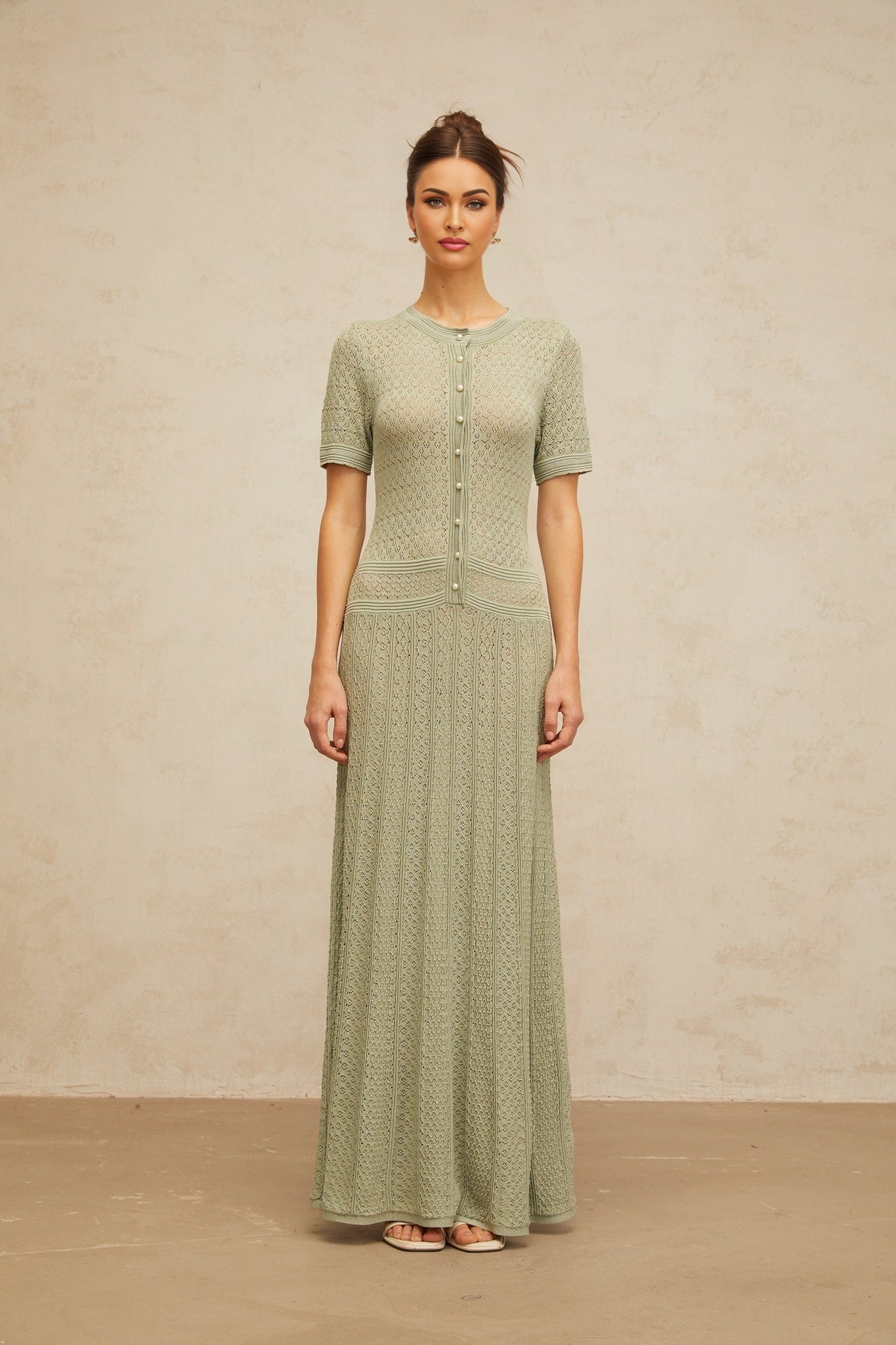 A long green maxi dress with shirred detailing and crochet knit texture