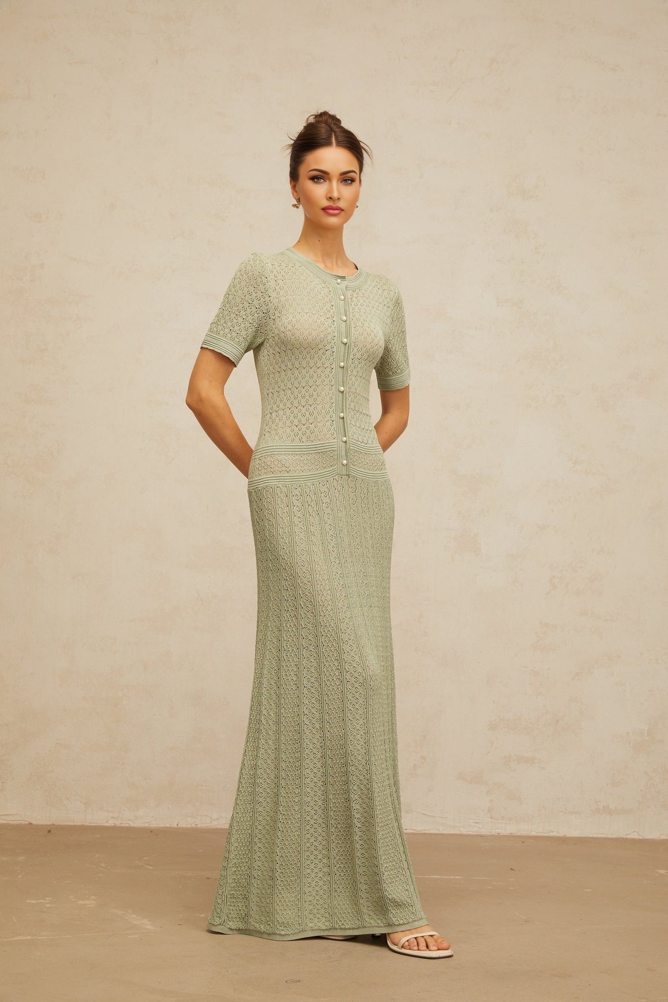 A long green maxi dress with shirred detailing and crochet knit texture