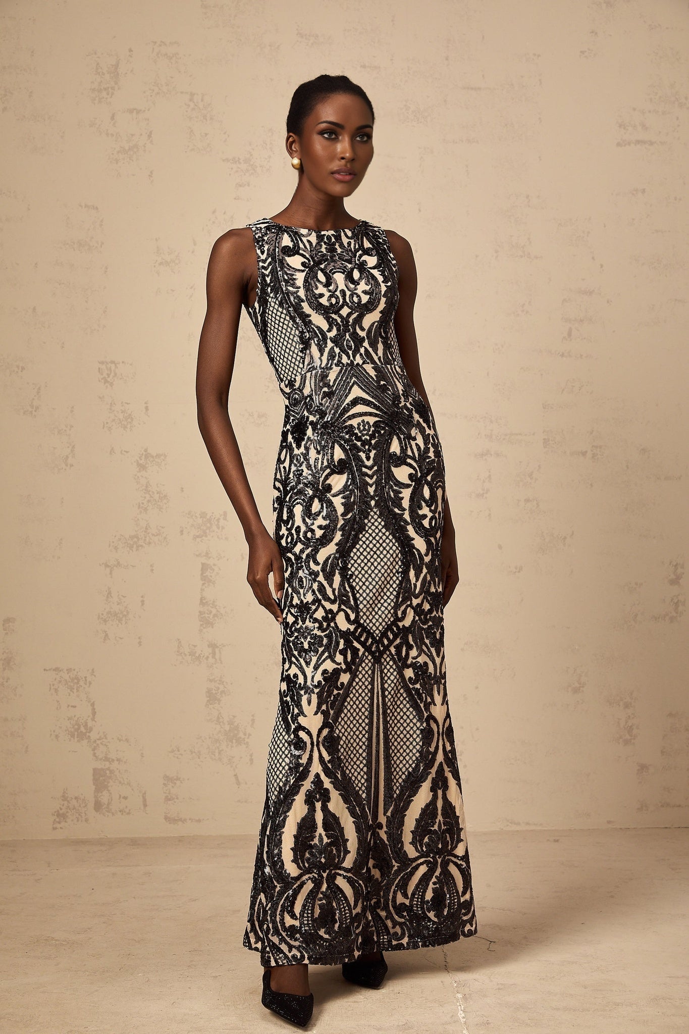 A long mesh maxi dress with sequin embellishments called Annie sparkling with a flowing silhouette