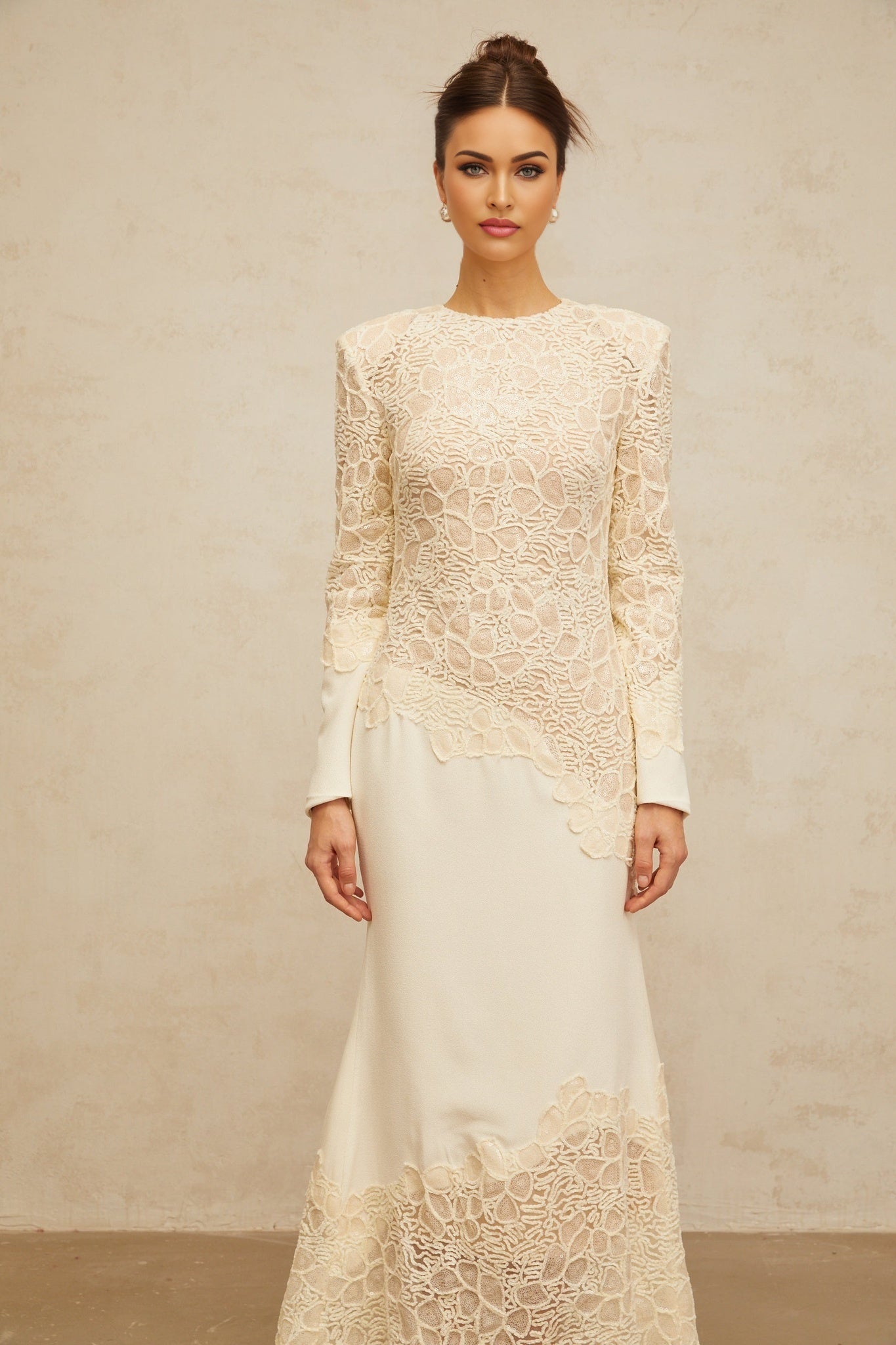 A long offwhite maxi dress with textured floral embroidery and sequin details named Mathilde