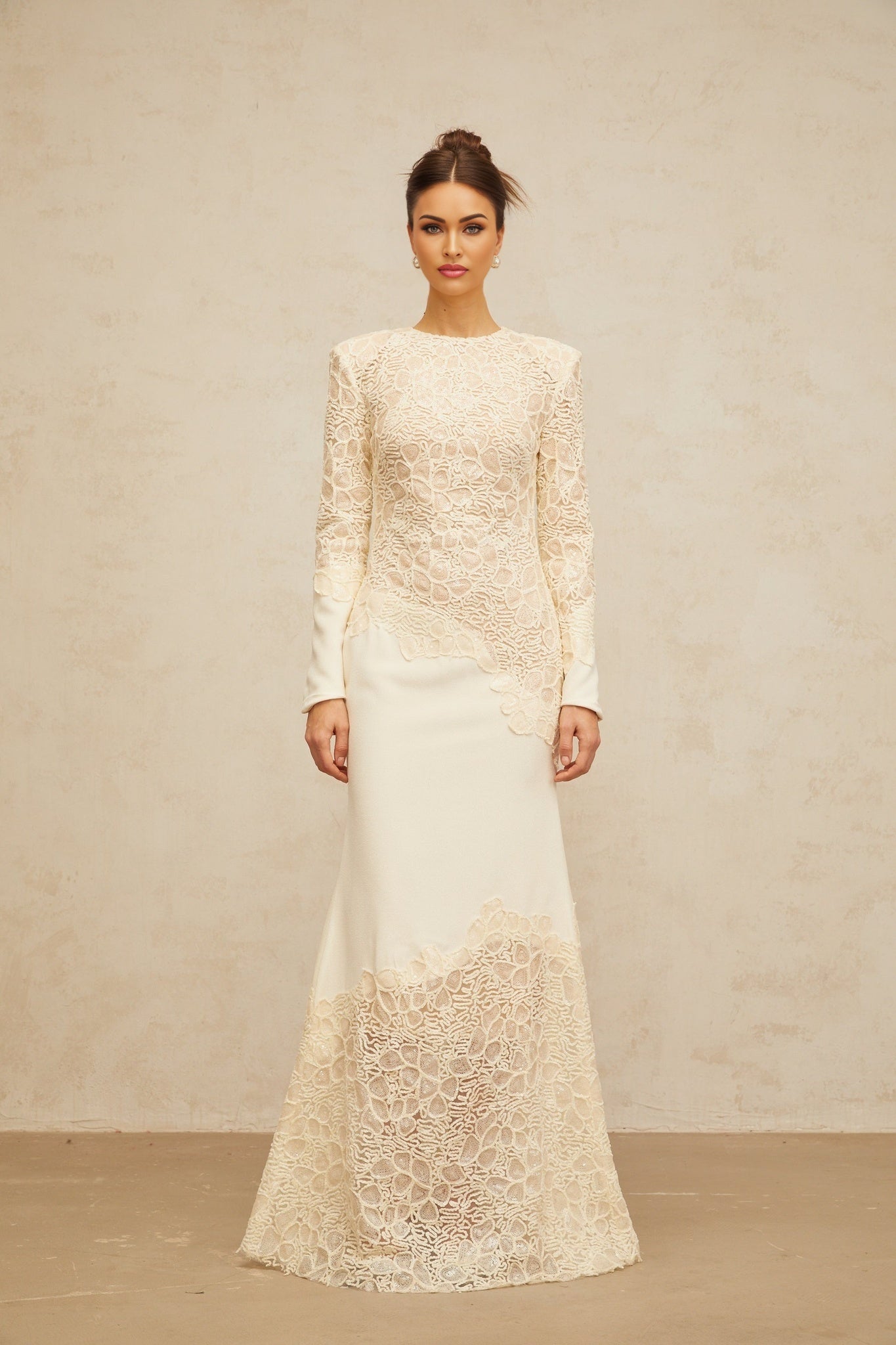 A long offwhite maxi dress with textured floral embroidery and sequin details named Mathilde