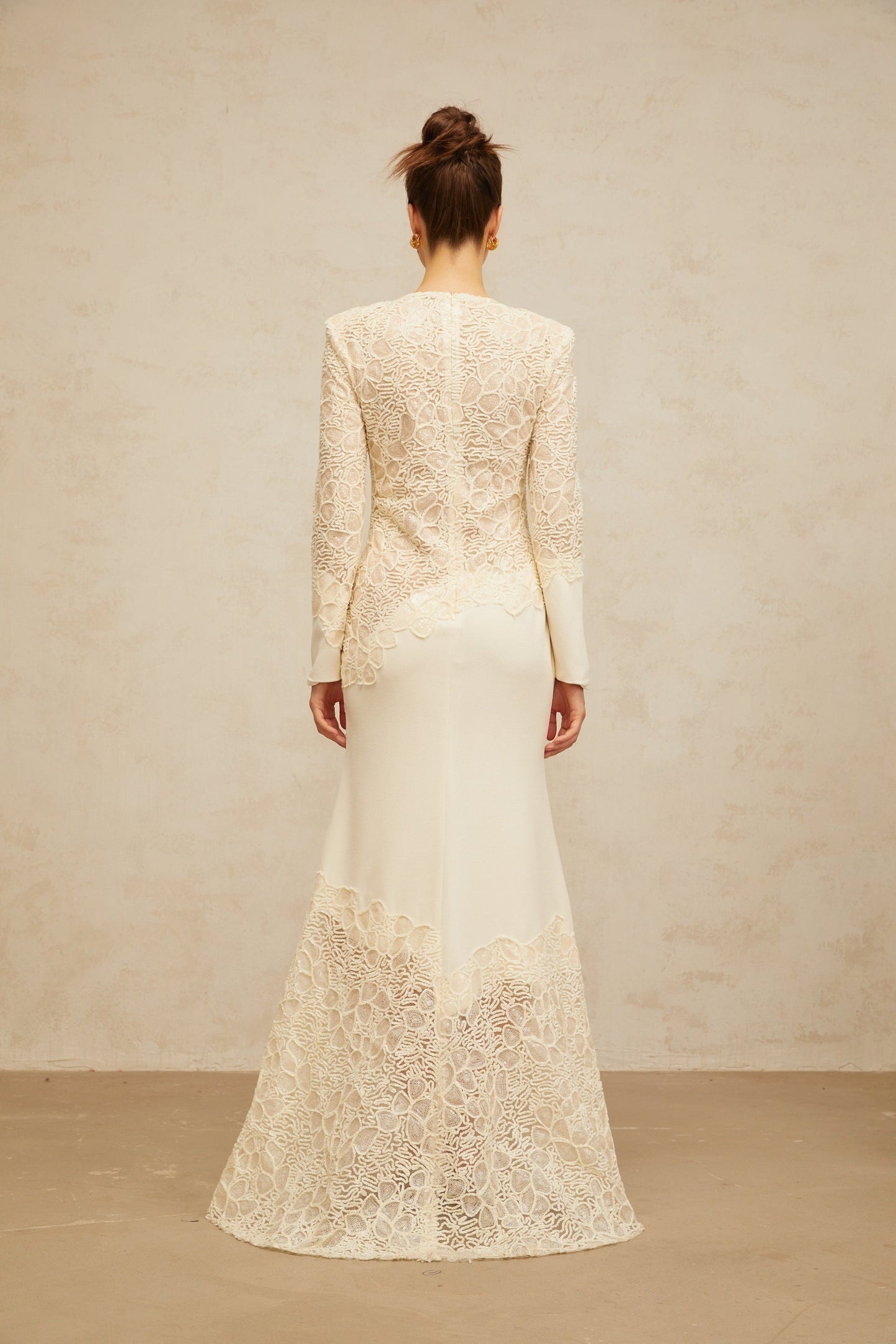 A long offwhite maxi dress with textured floral embroidery and sequin details named Mathilde