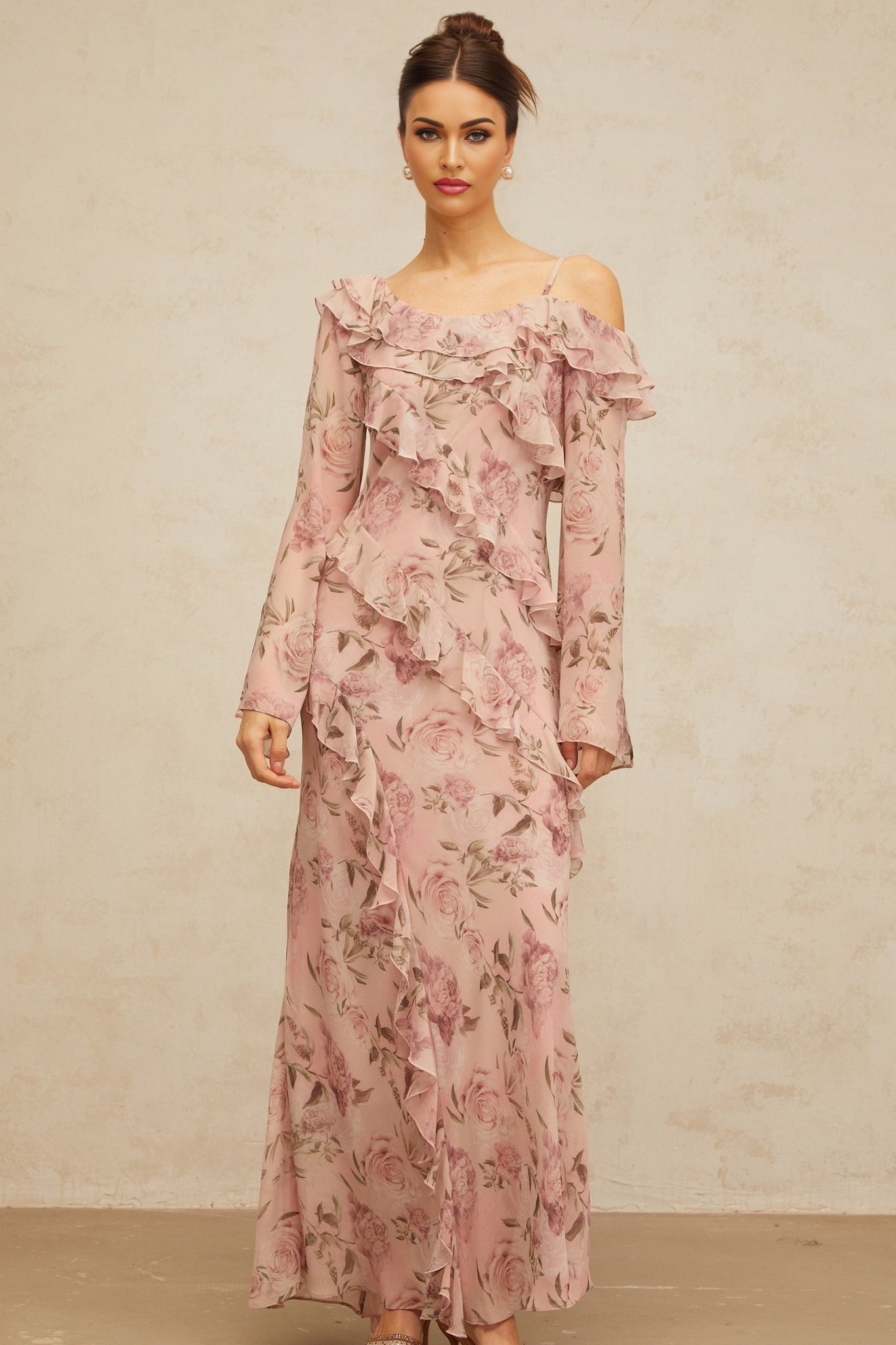 A long pink maxi dress with a floral print pattern and ruffled details named Clemence
