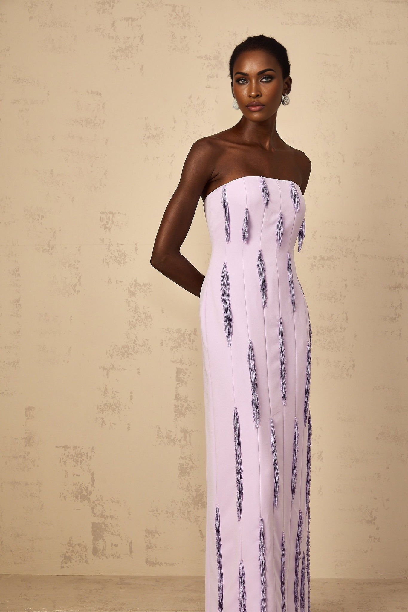 A long purple maxi dress with beaded fringe detailing named Émilie