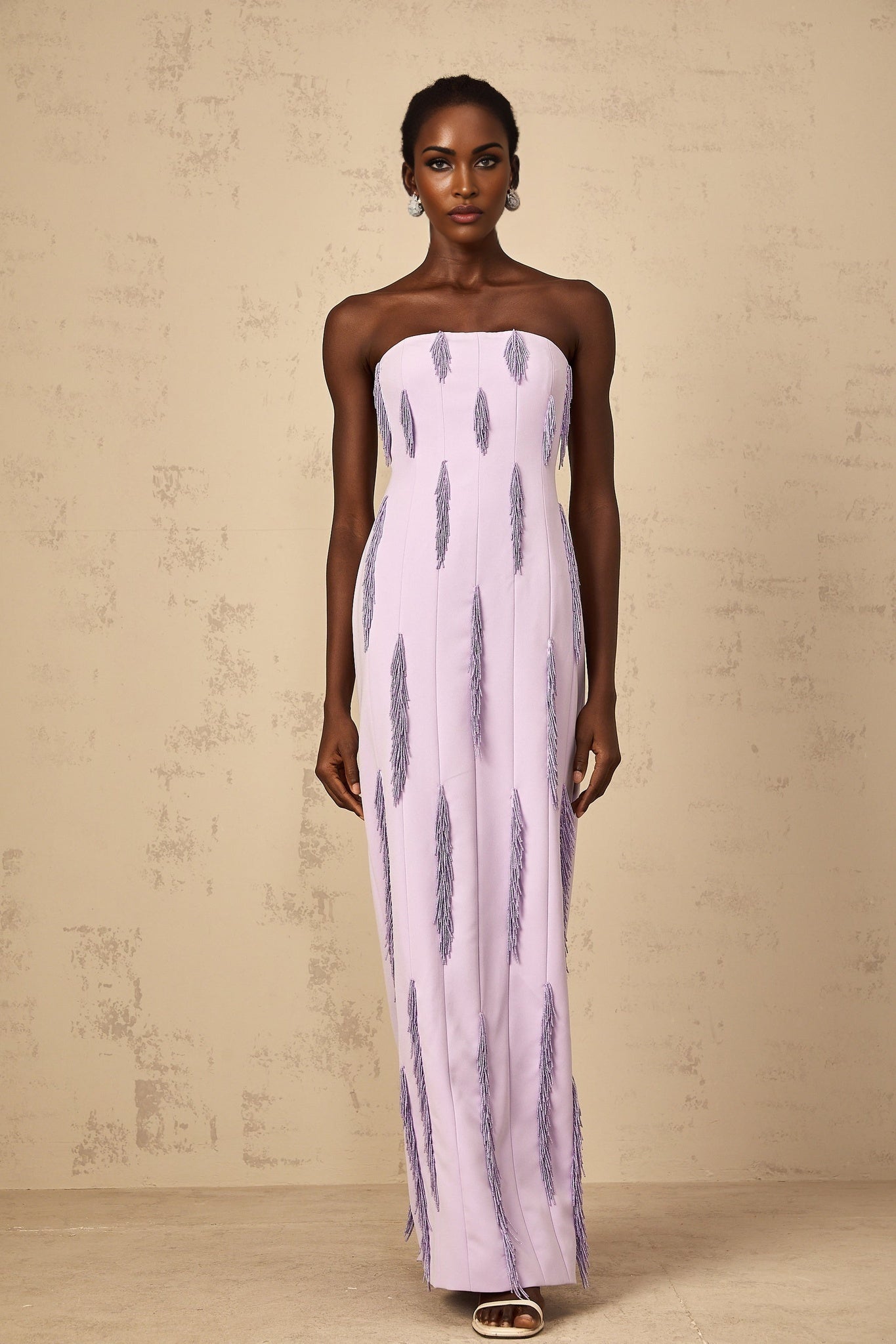 A long purple maxi dress with beaded fringe details and a flowy silhouette named Émilie