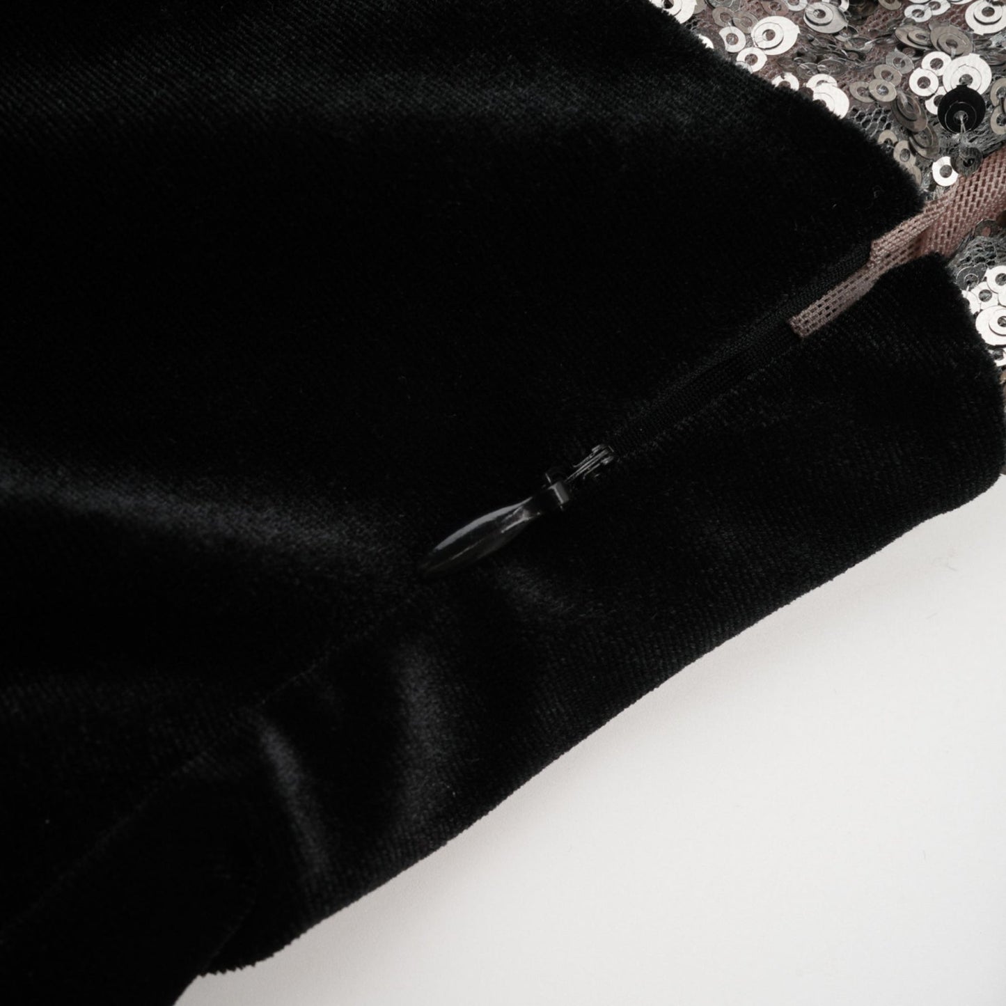 A long sequined maxi dress with an asymmetric hemline featuring a shimmering pattern named Juliette