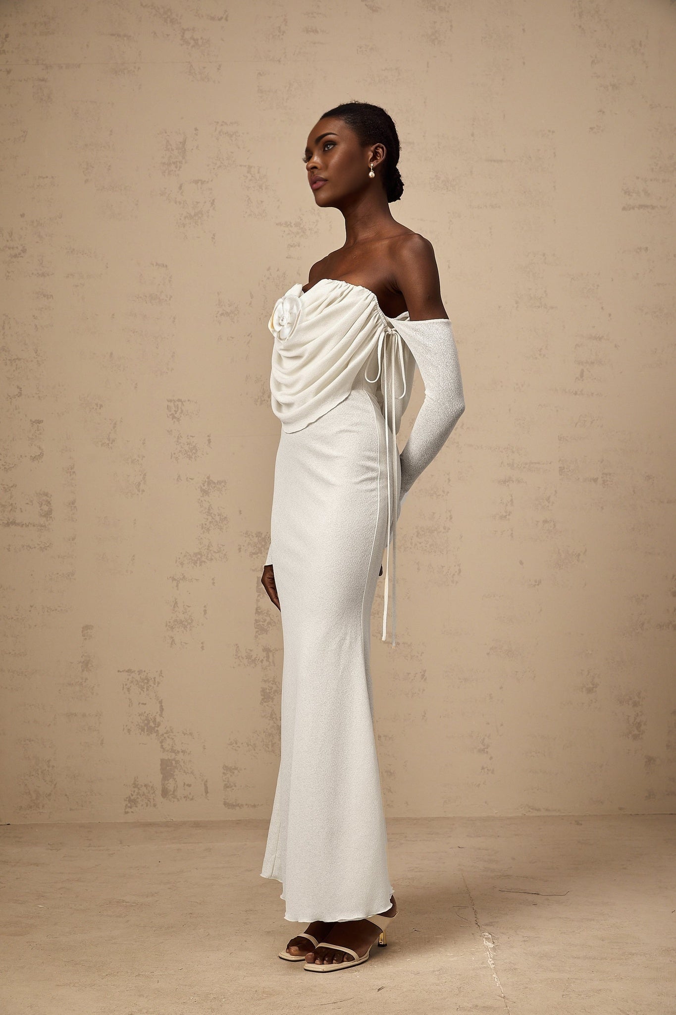 A long strapless maxi dress with a ruched bodice and floral applique details in a soft fabric