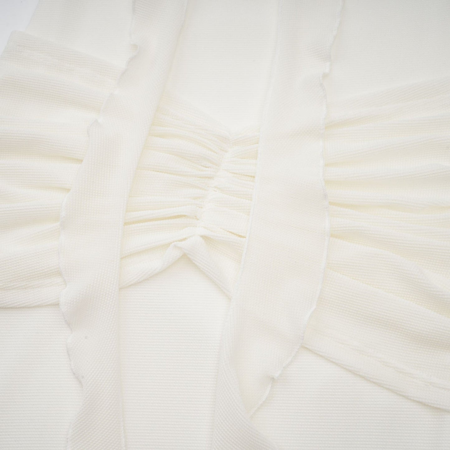 A long white knit maxi dress with glittered floral appliques adorning the fabric named Wanda