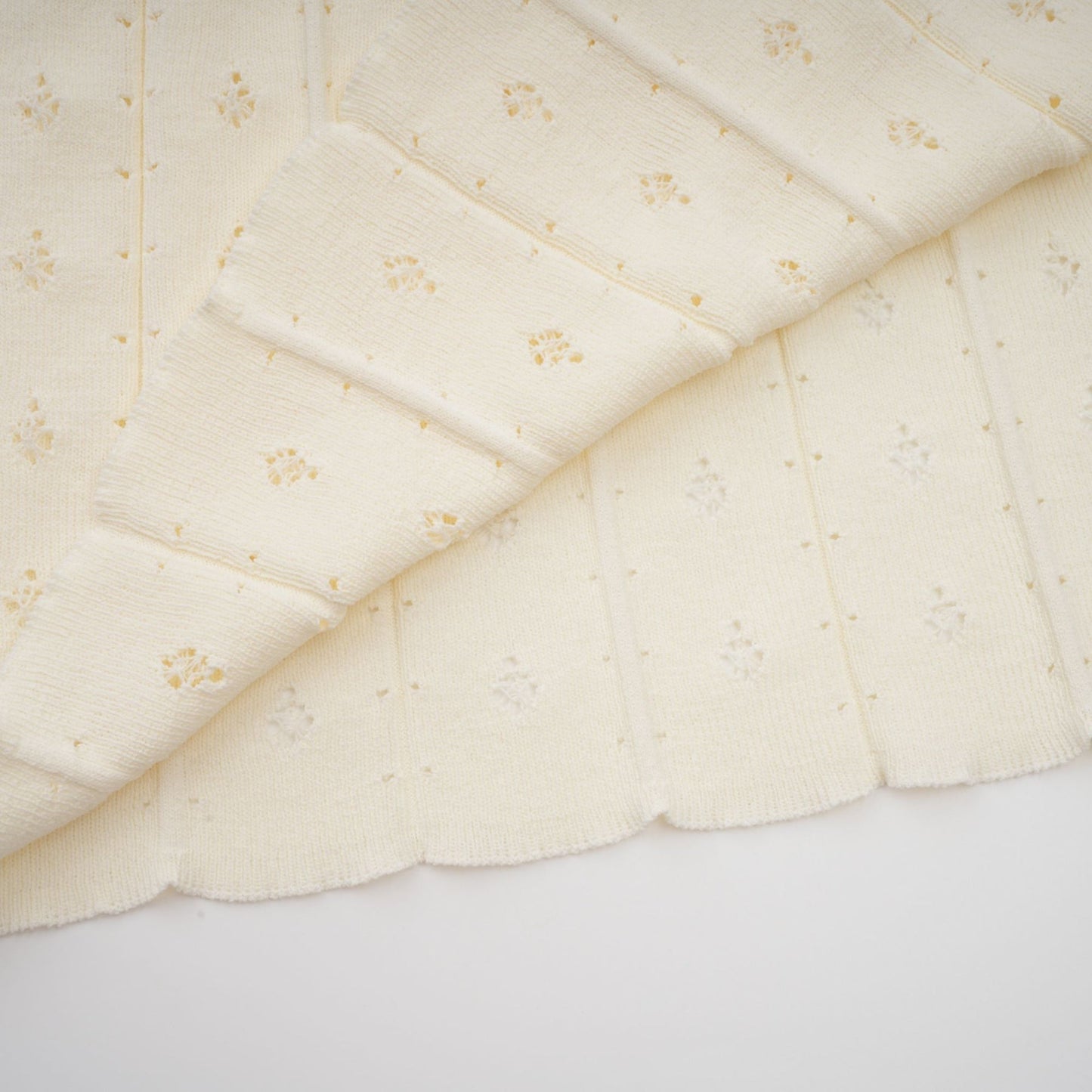 A long white knitted maxi dress with faux pearl embellishments