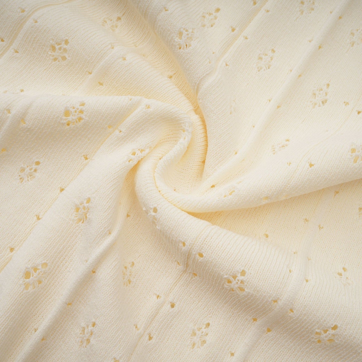 A long white knitted maxi dress with faux pearl embellishments
