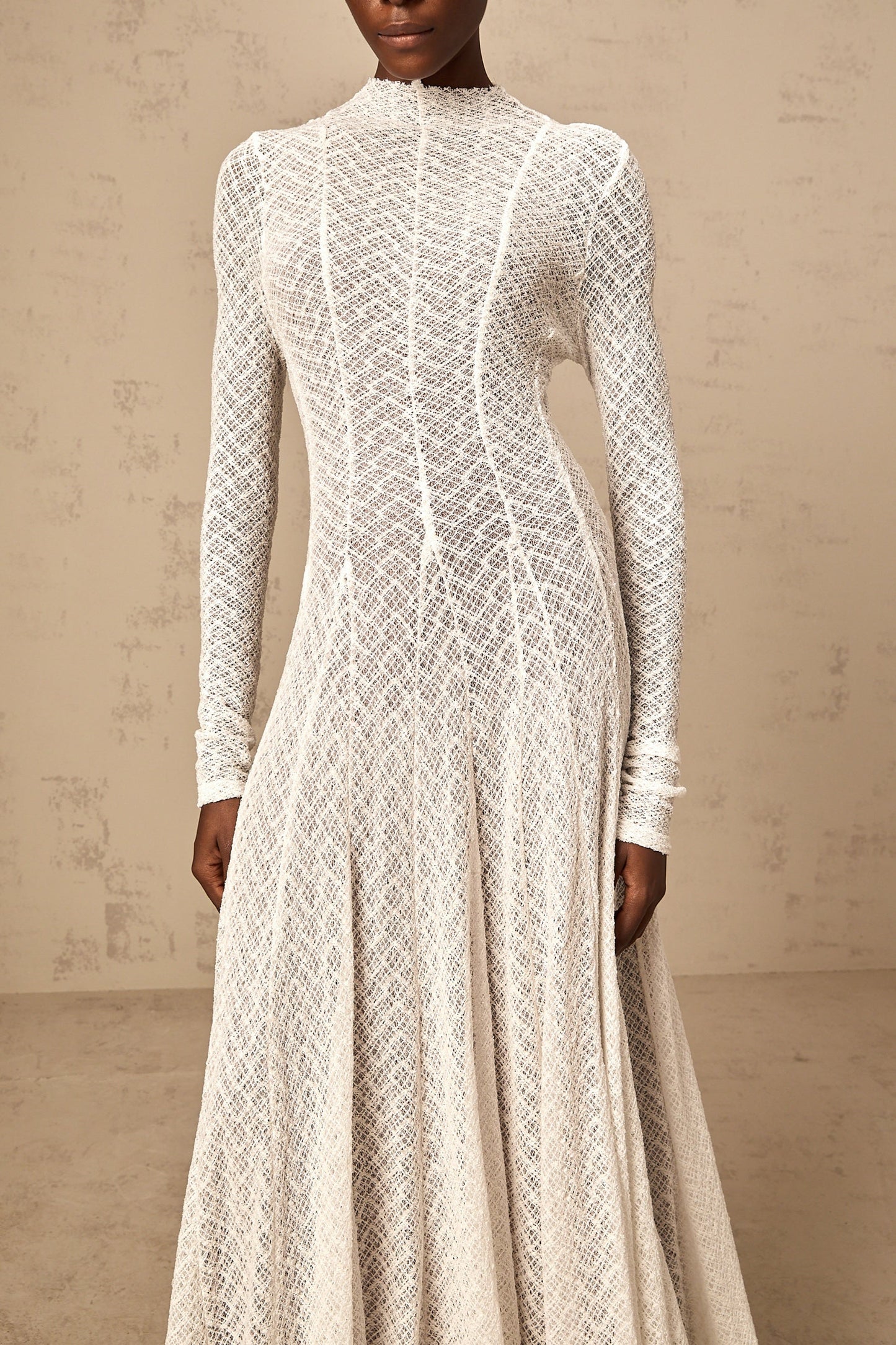 A long white lace maxi dress with a wavy pattern design named Athena