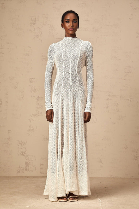 A long white lace maxi dress with a wavy pattern design named Athena