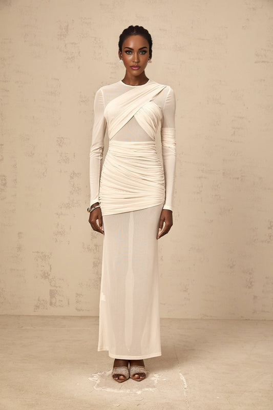 A long white maxi dress with ruched tulle fabric and a flowing silhouette