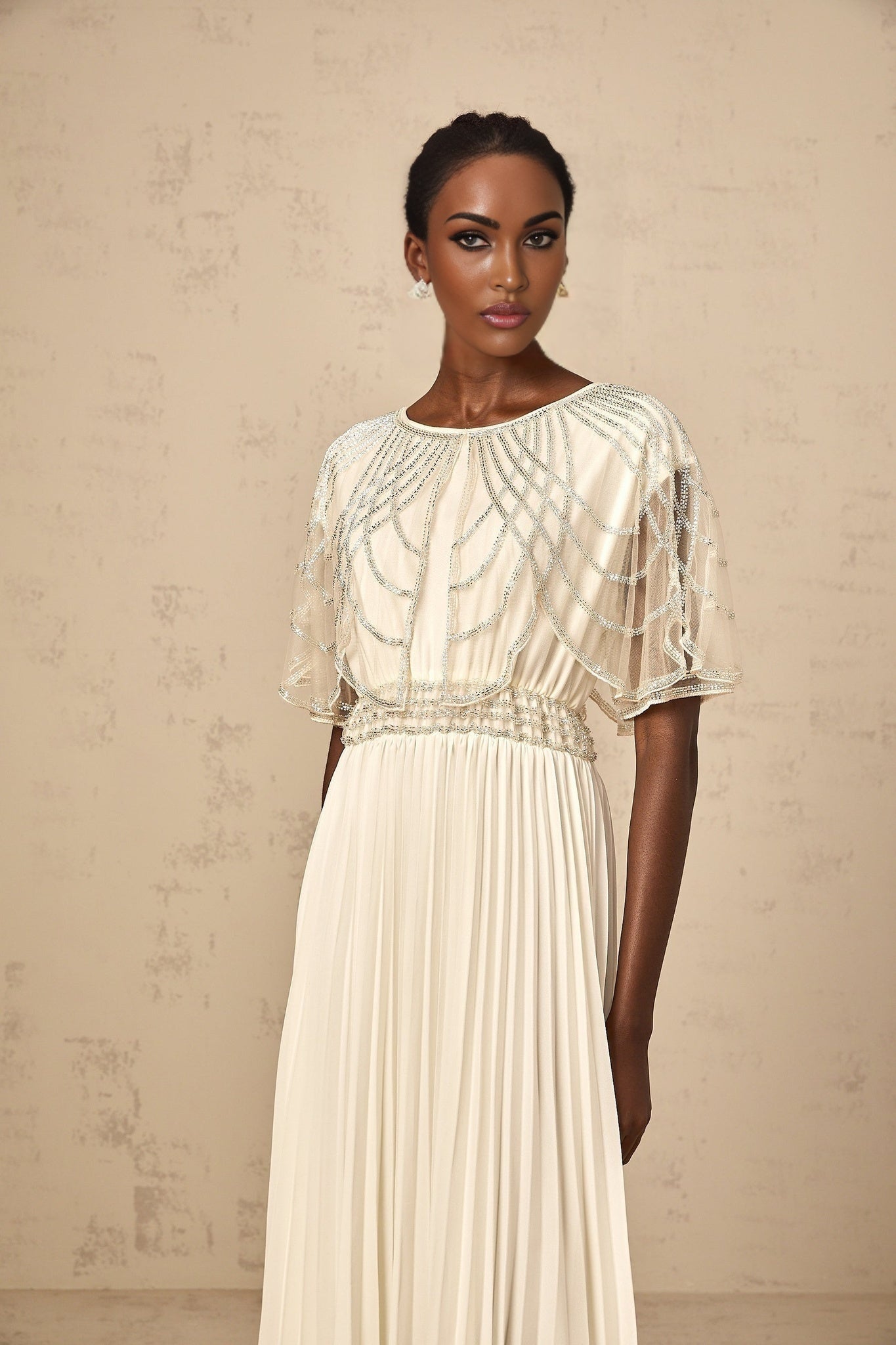 A long white pleated maxi dress with crystal embellishments called Xenia