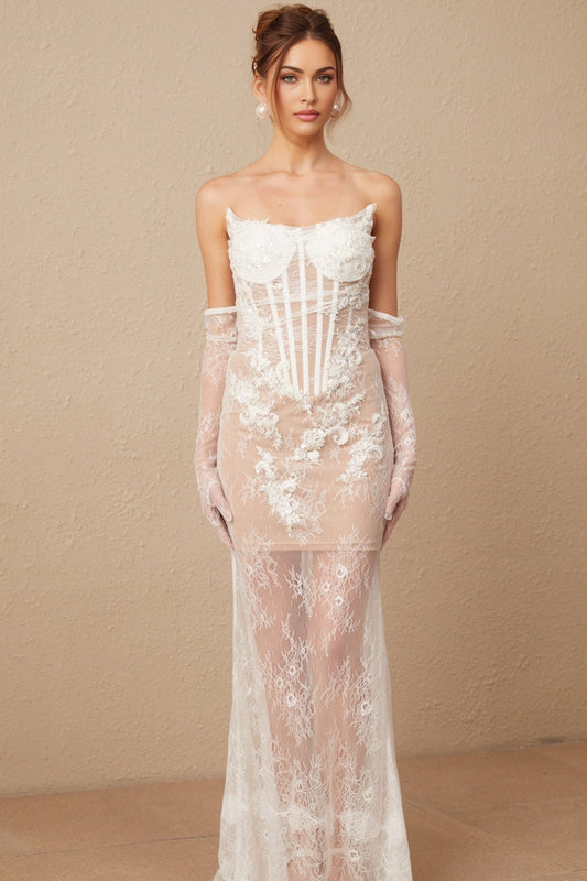 A long white tulle maxi dress with a corset bodice featuring delicate floral embroidery in pastel colors The dress has a sweetheart neckline and a flowing skirt