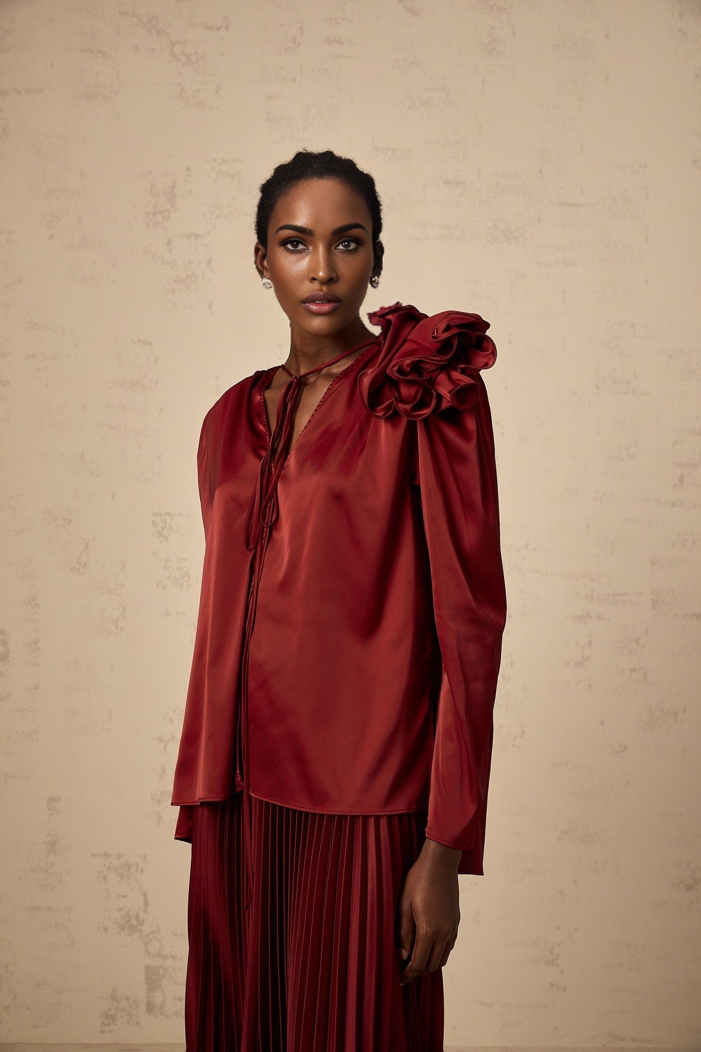 A matching set consisting of a blouse and skirt in satin fabric with floral applique details named Colette