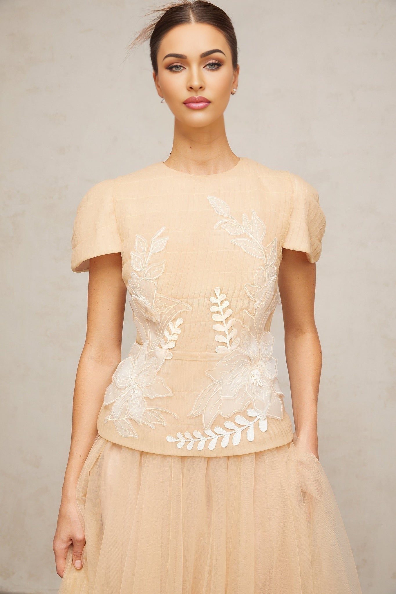 A matching set consisting of a tulle top and skirt decorated with floral applique designs named Ludivine