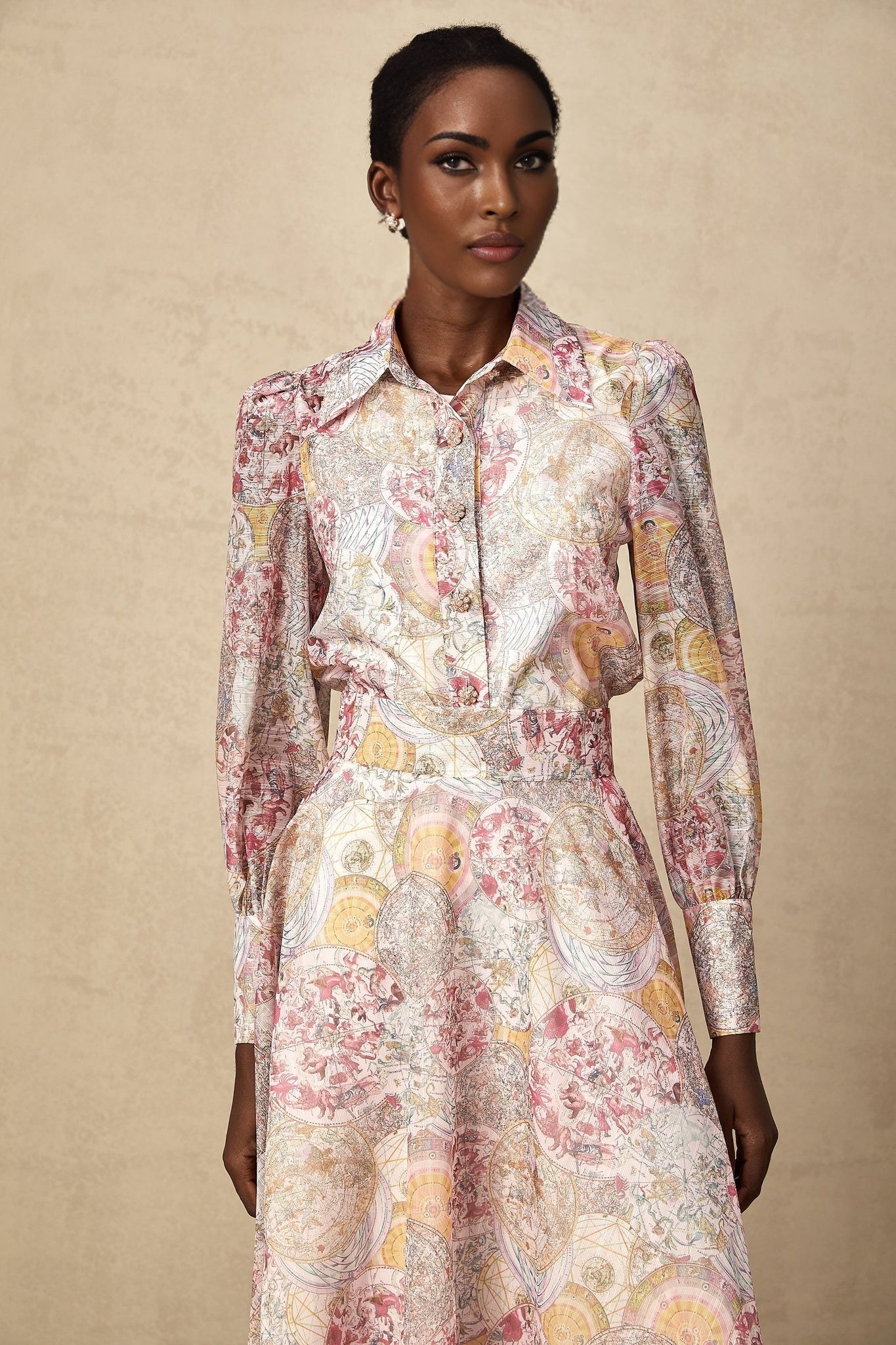 A matching set featuring a cherry pink shirt and skirt with a pattern print design both pieces coordinate in color and style