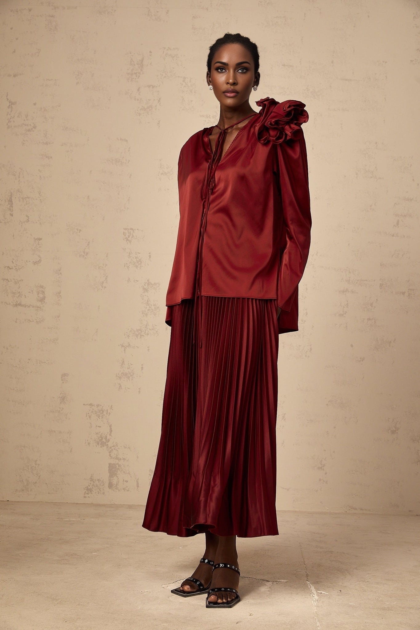 A matching set featuring a satin blouse and skirt adorned with flower appliques named Colette