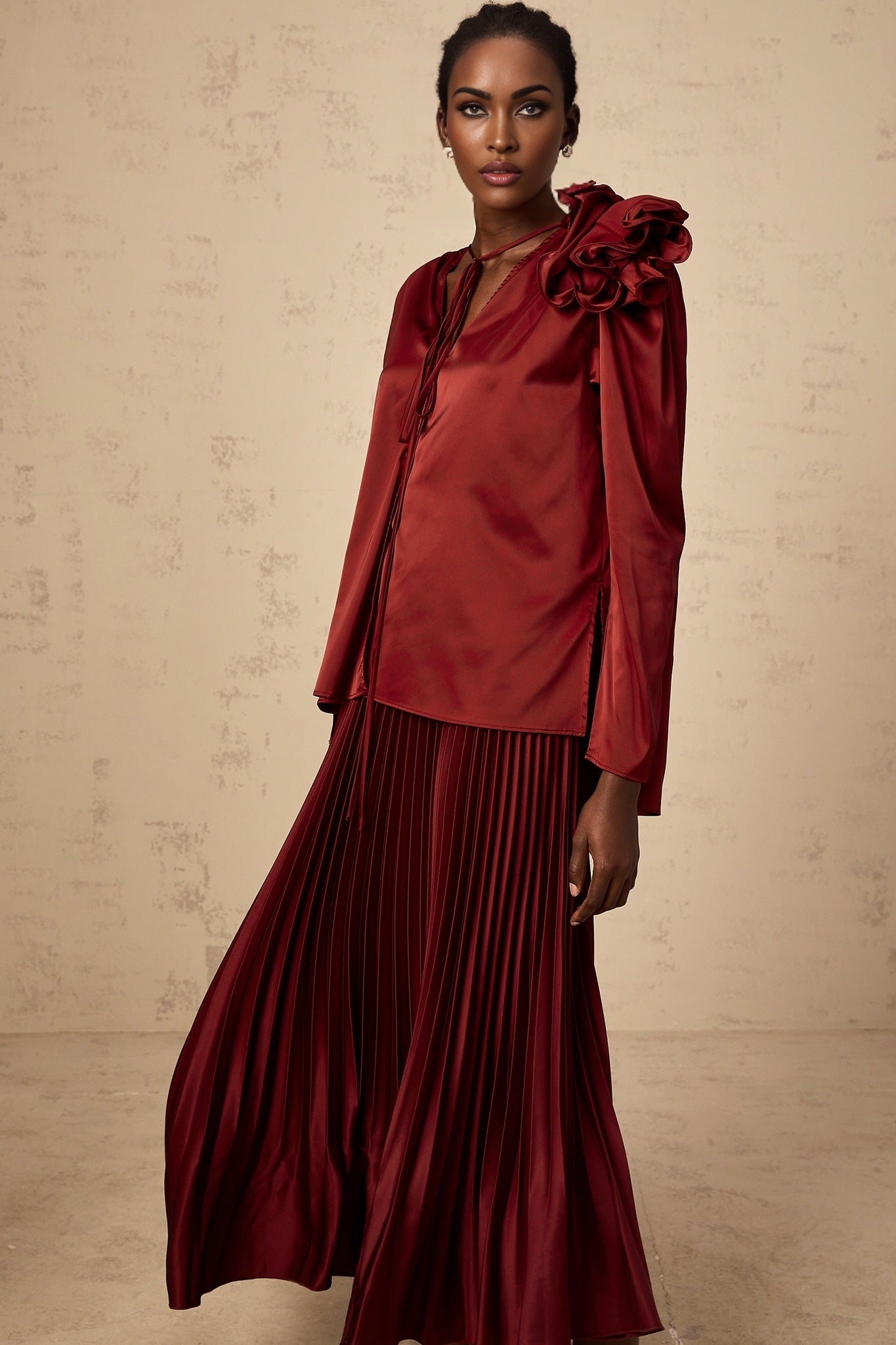 A matching set featuring a satin blouse and skirt with floral applique details named Colette