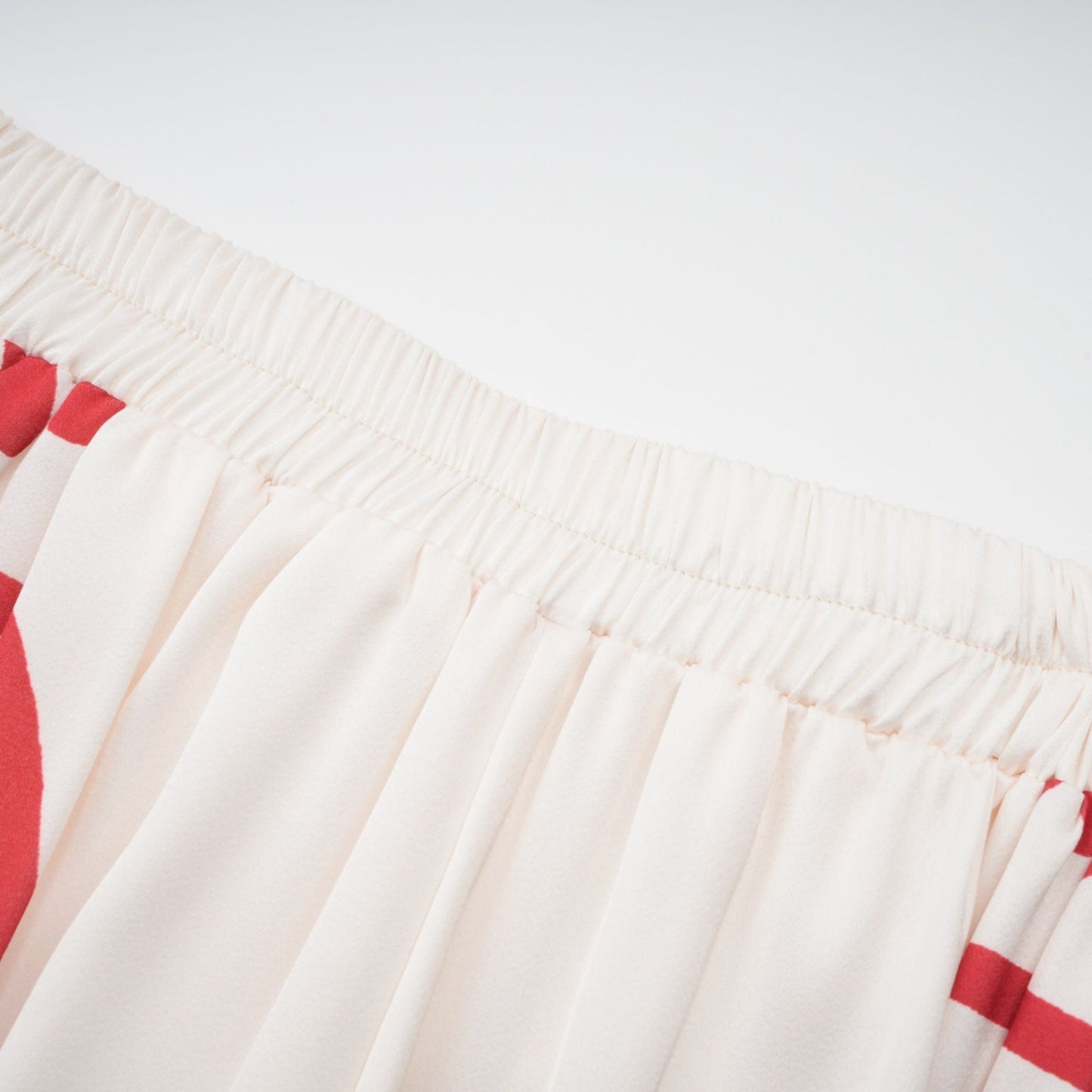 A matching set featuring an Amaranta graphic print shirt and trousers worn together on a model