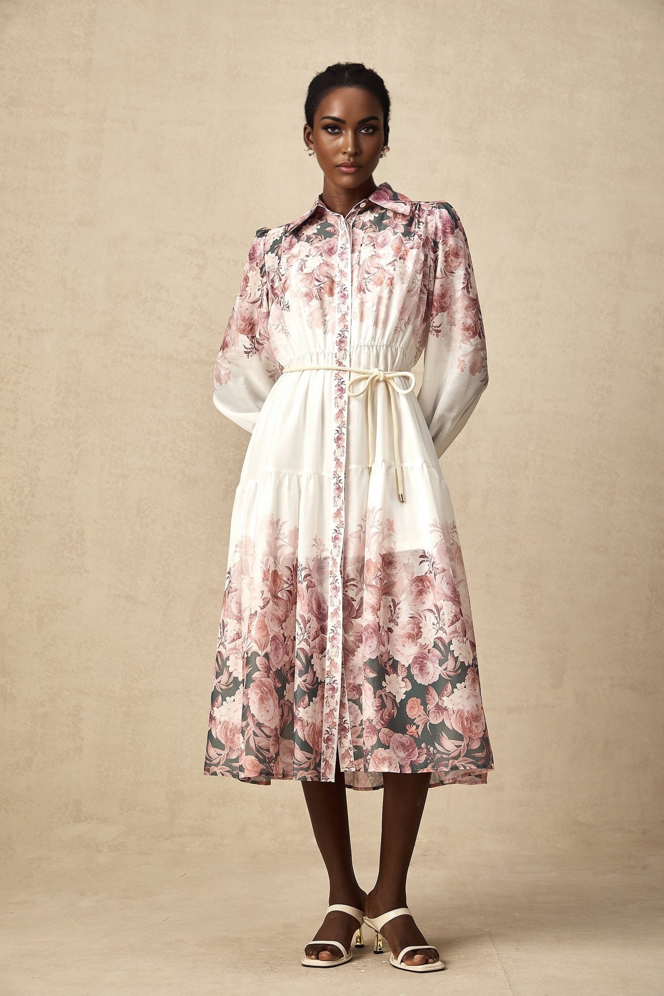 A midi dress with a floral print pattern featuring lantern sleeves and a design called Carina