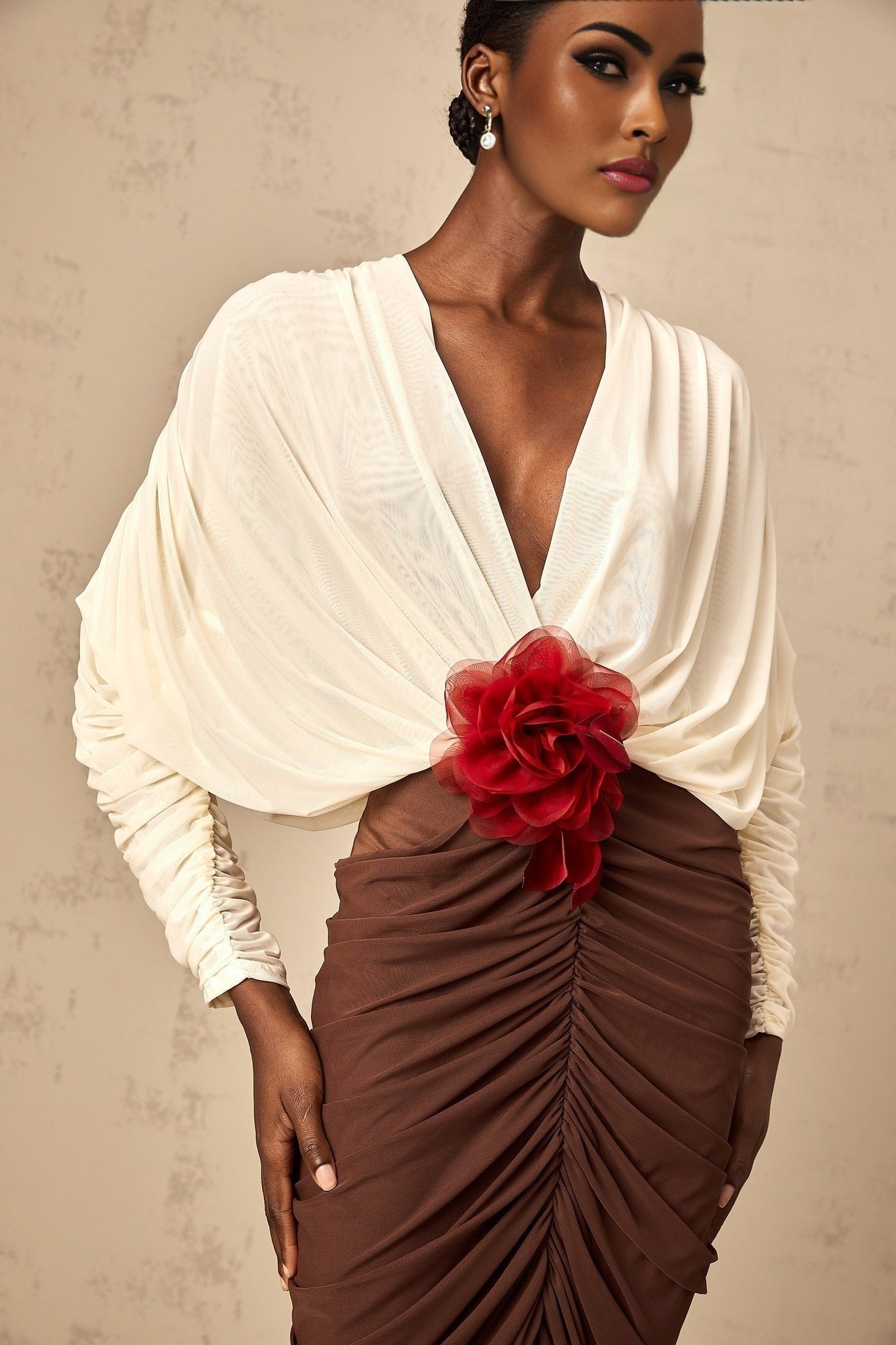 A midi dress with ruched detailing featuring color blocking and a flower brooch accent named Leontine