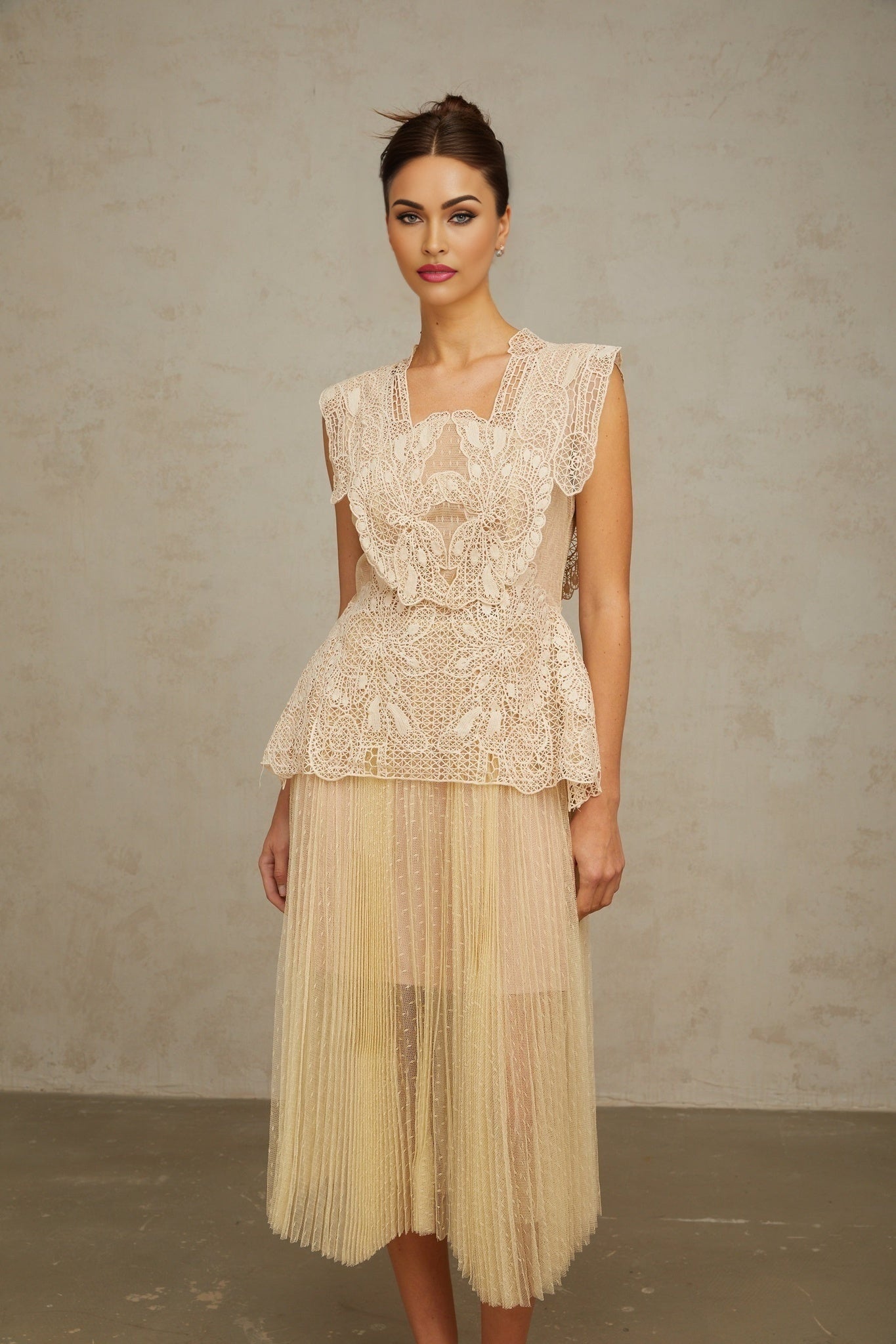 A neutraltoned midi dress with floral lace panels and tulle fabric named Celeste featuring a delicate and feminine design