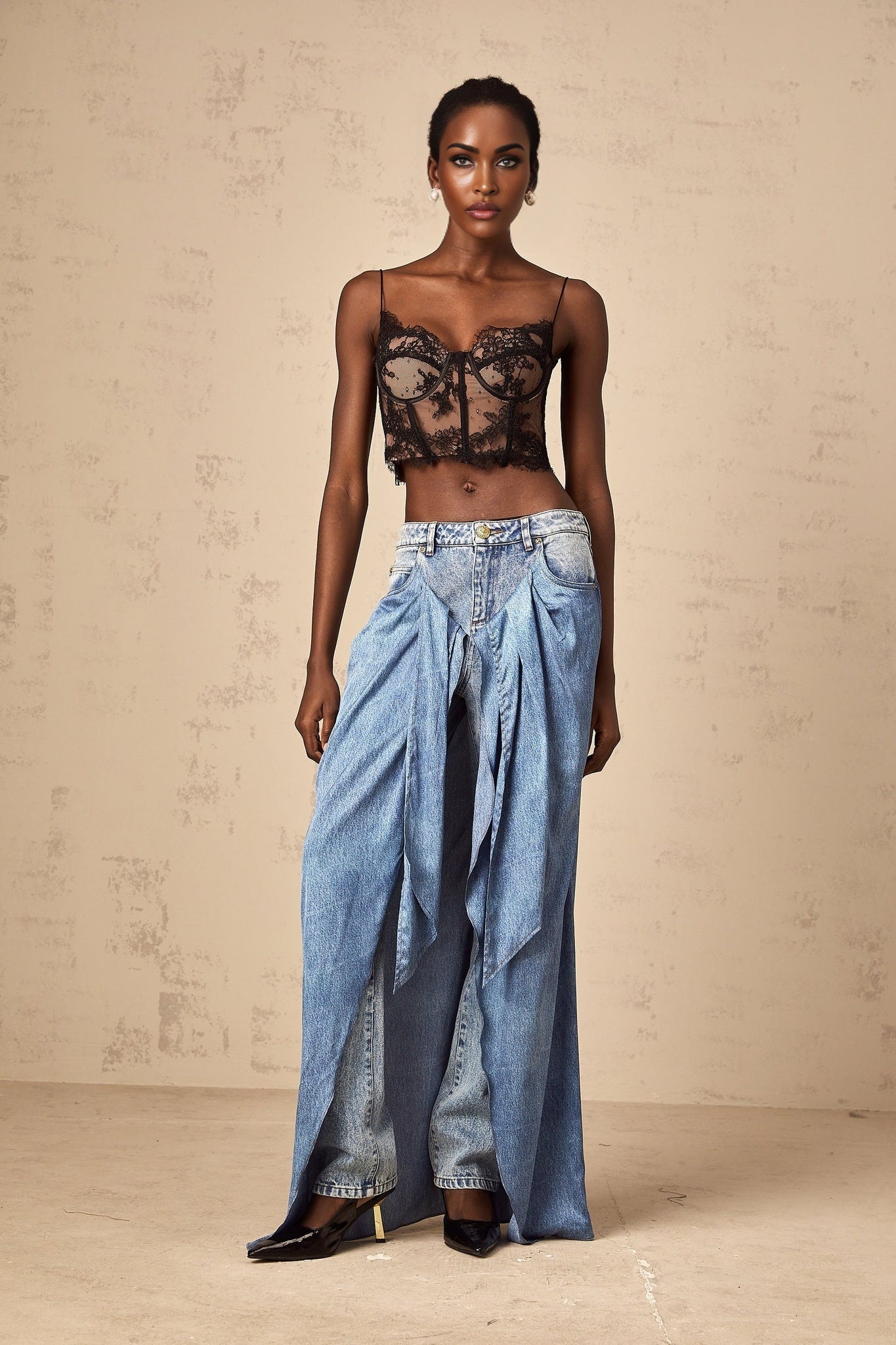A pair of blue layered denim jeans called Ysabella featuring a multi tiered design with overlapping fabric panels