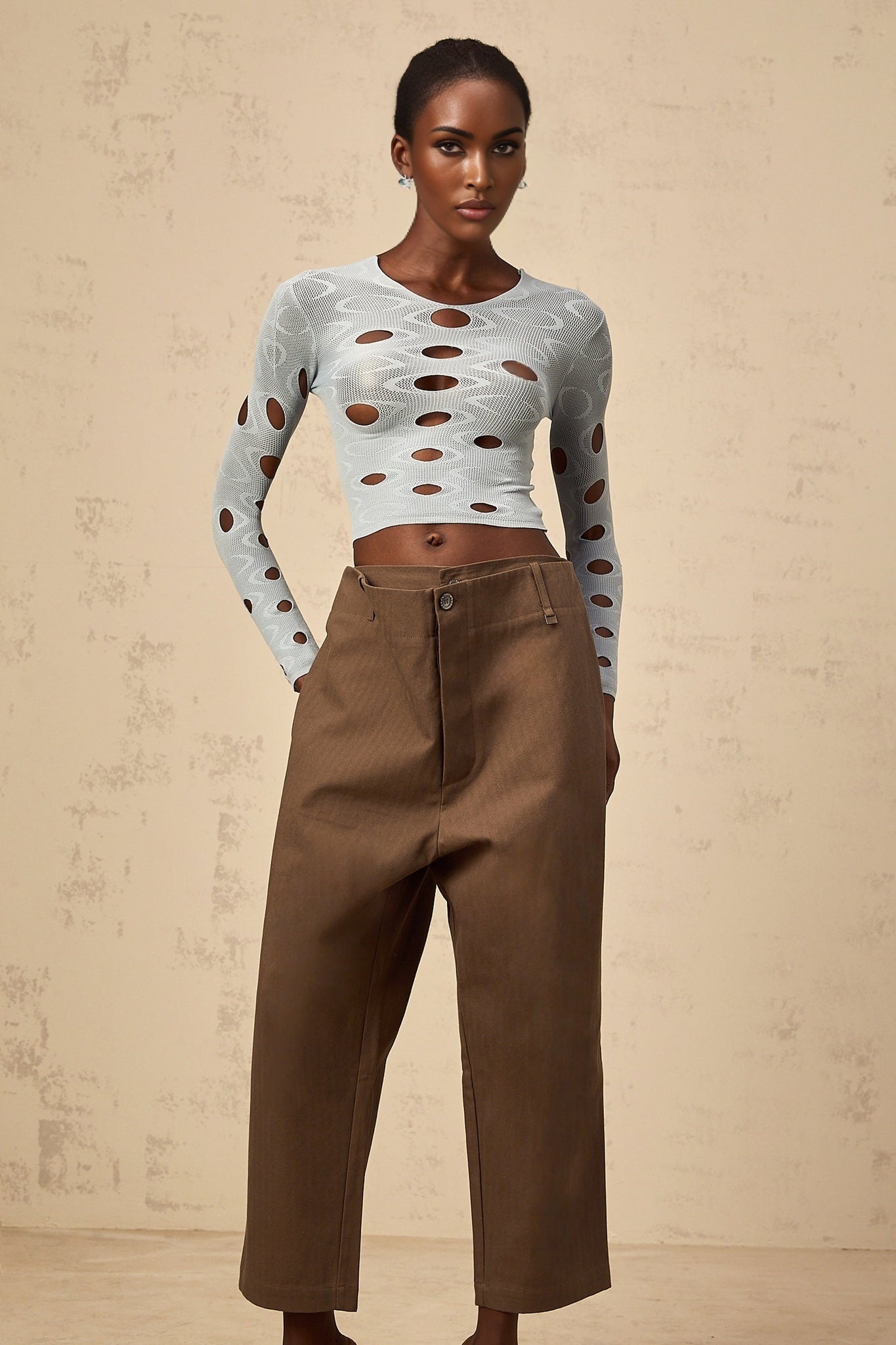 A pair of brown wideleg trousers with shirred detailing and a cropped length named Ophélie