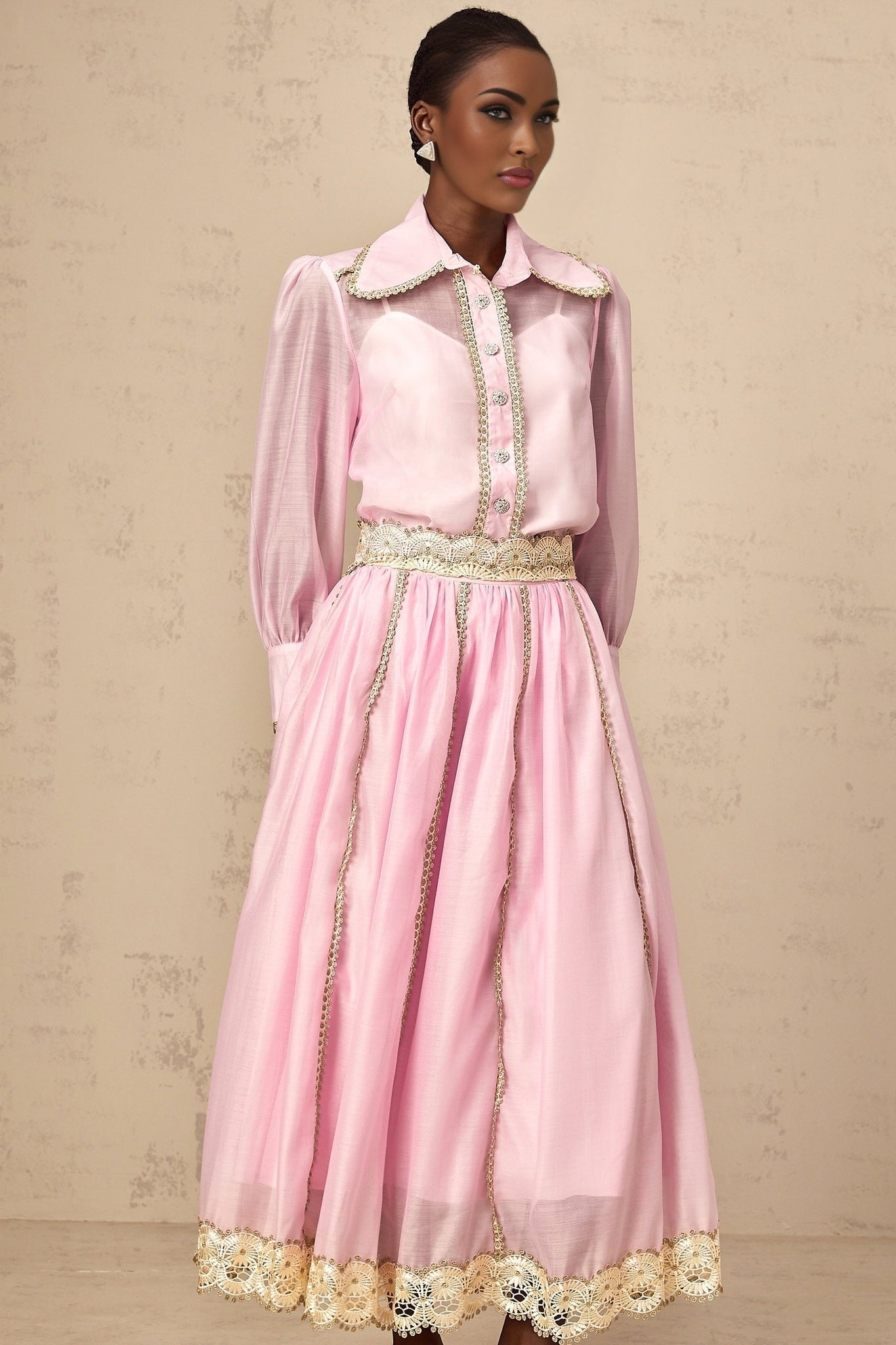 A pink matching set consisting of a lacetrimmed shirt and skirt from Frida The top has delicate lace details and the skirt coordinates with the shirt for a feminine and cohesive look