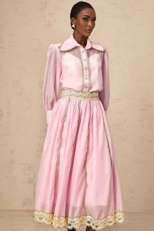 A pink matching set consisting of a lacetrimmed shirt and skirt from Frida The top has delicate lace details and the skirt coordinates with the shirt for a feminine and cohesive look