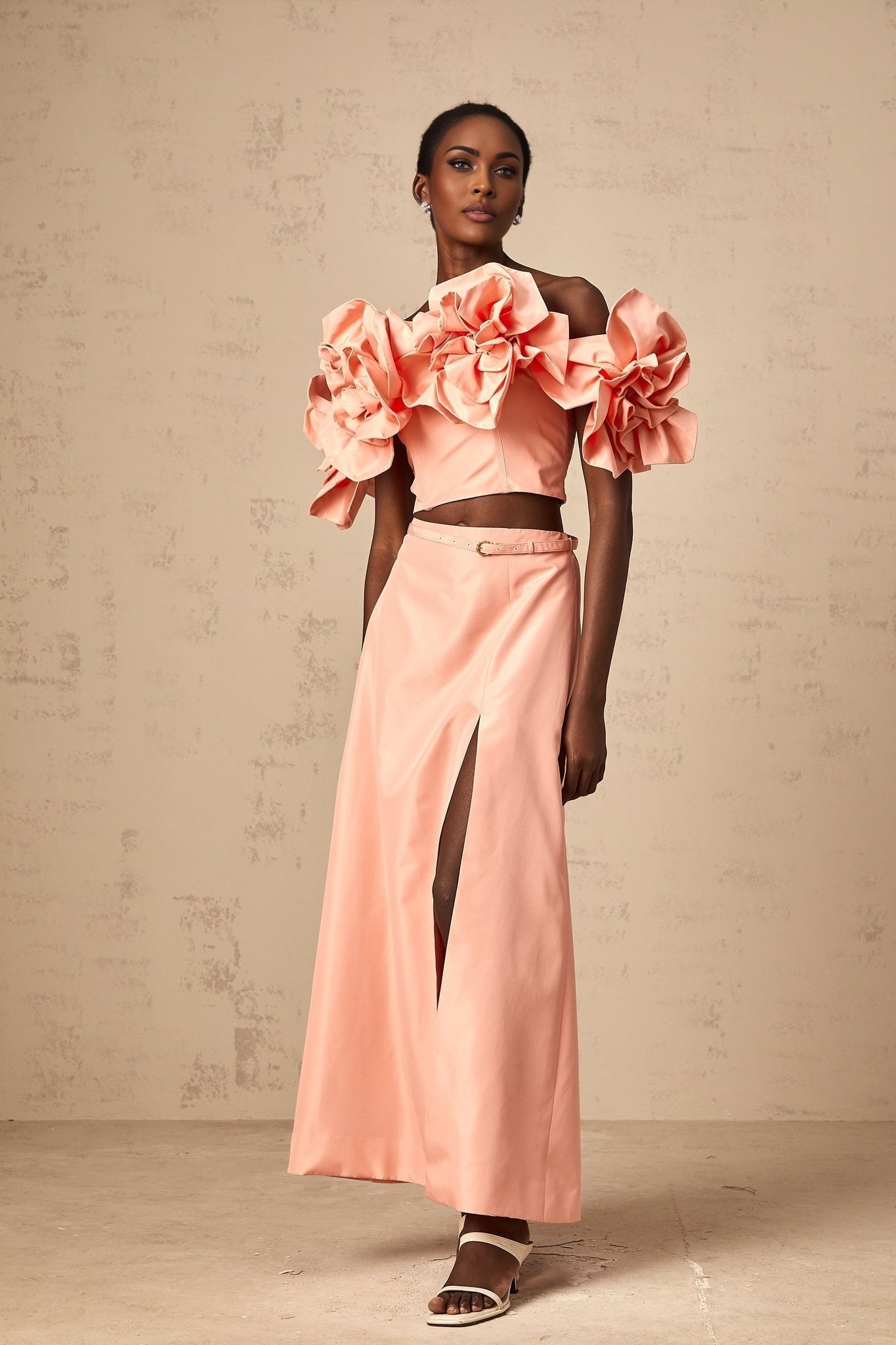 A pink matching set featuring a top and skirt with floral applique detailing named Yvette