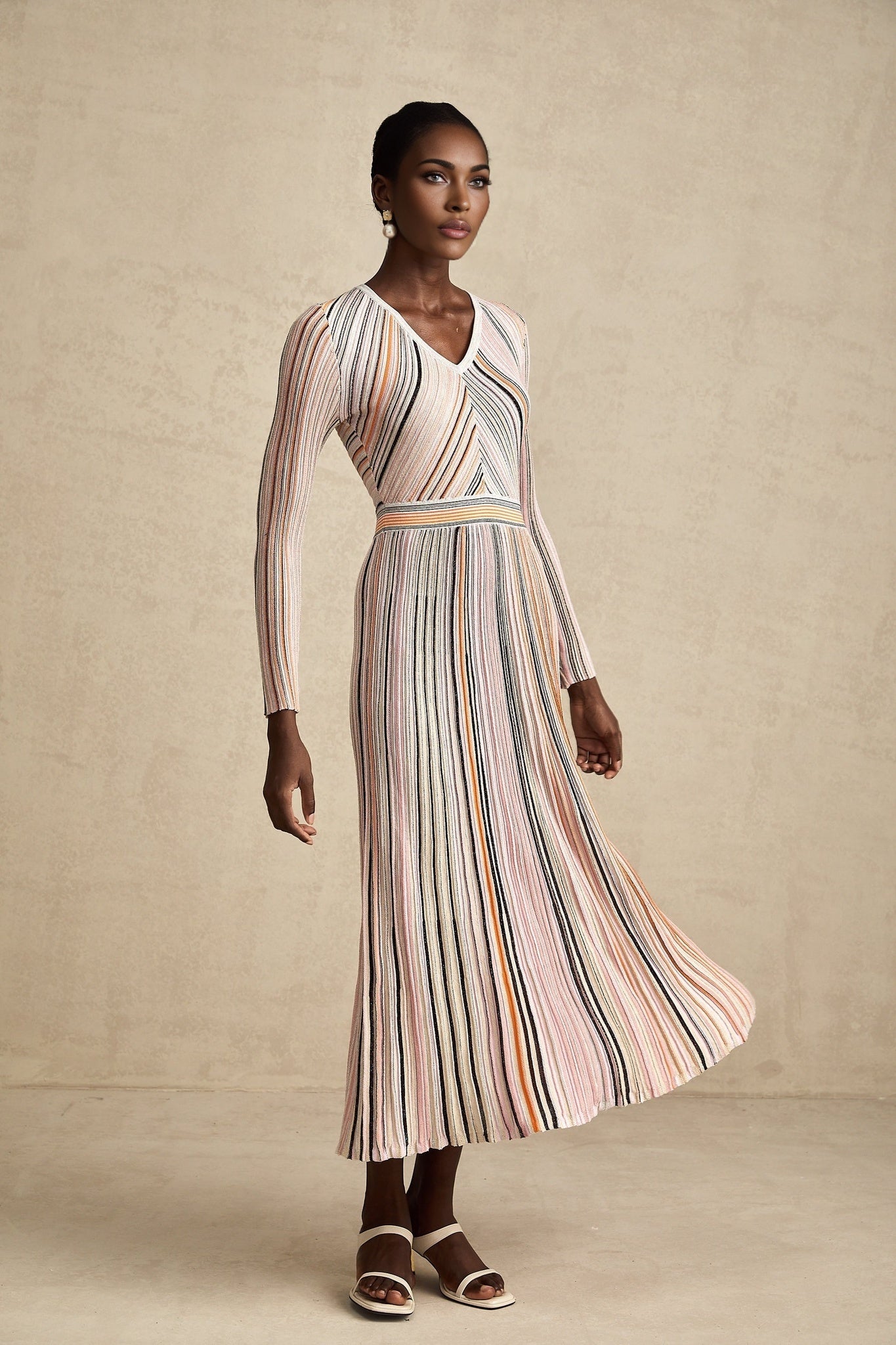 A pink metallic midi dress with pleated design named Mathilde featuring a shimmering finish and midlength hemline