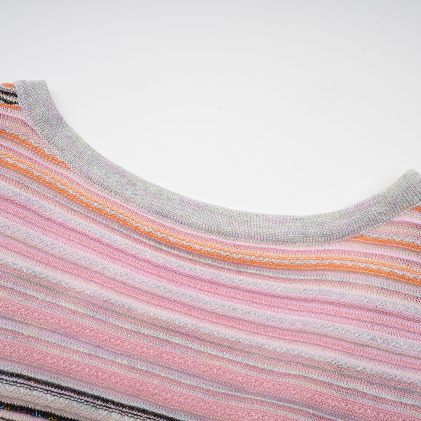 A pink metallic pleated midi dress with a feminine silhouette named Mathilde shimmering in the light with its lustrous fabric and flowing pleats
