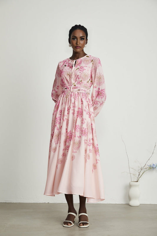 A pink midi dress with a floral print pattern featuring the name Yvette