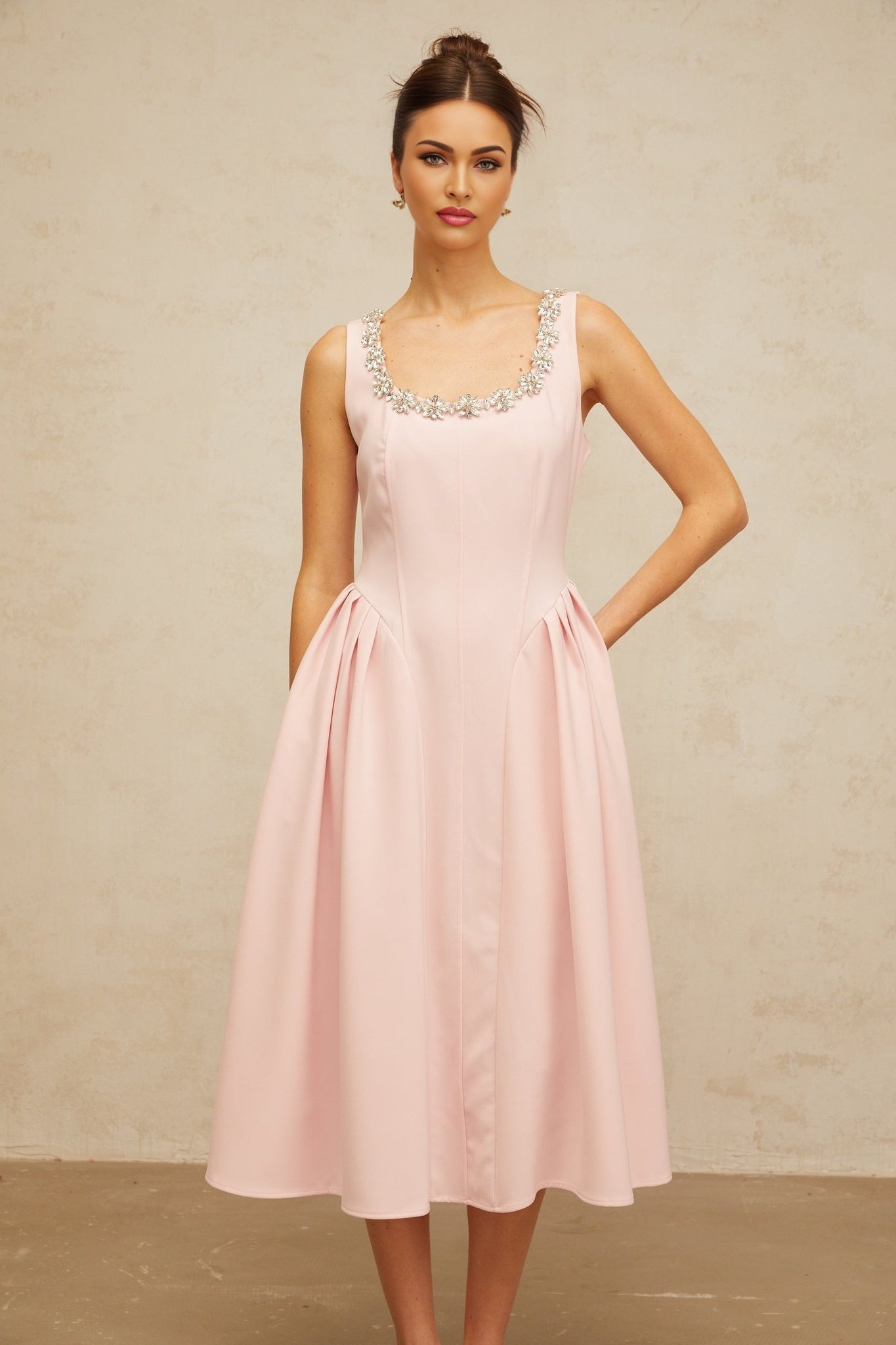A pink midi dress with crystal embellishments and pleated design named Beatrice