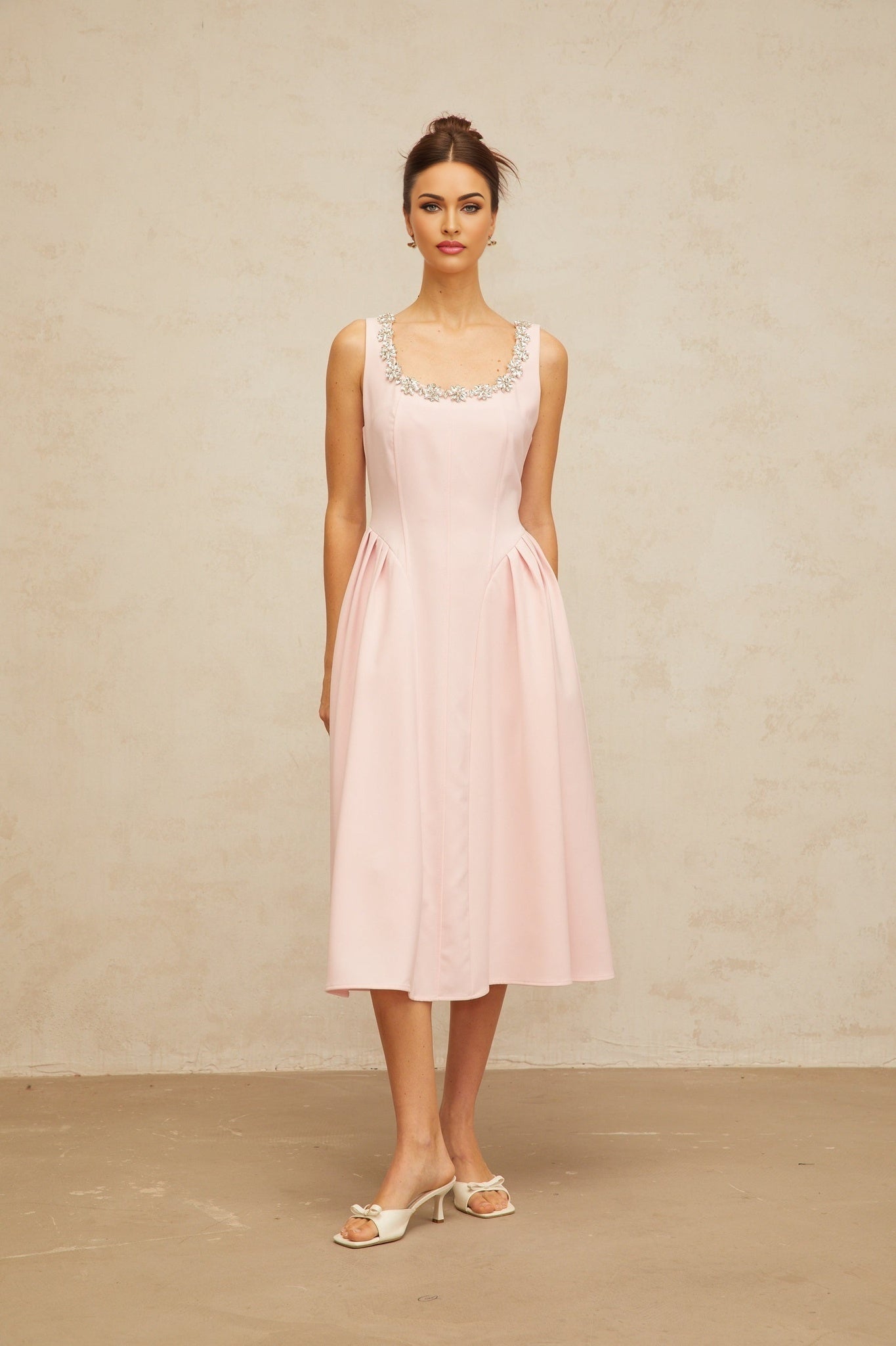 A pink midi dress with crystal embellishments and pleated details named Beatrice