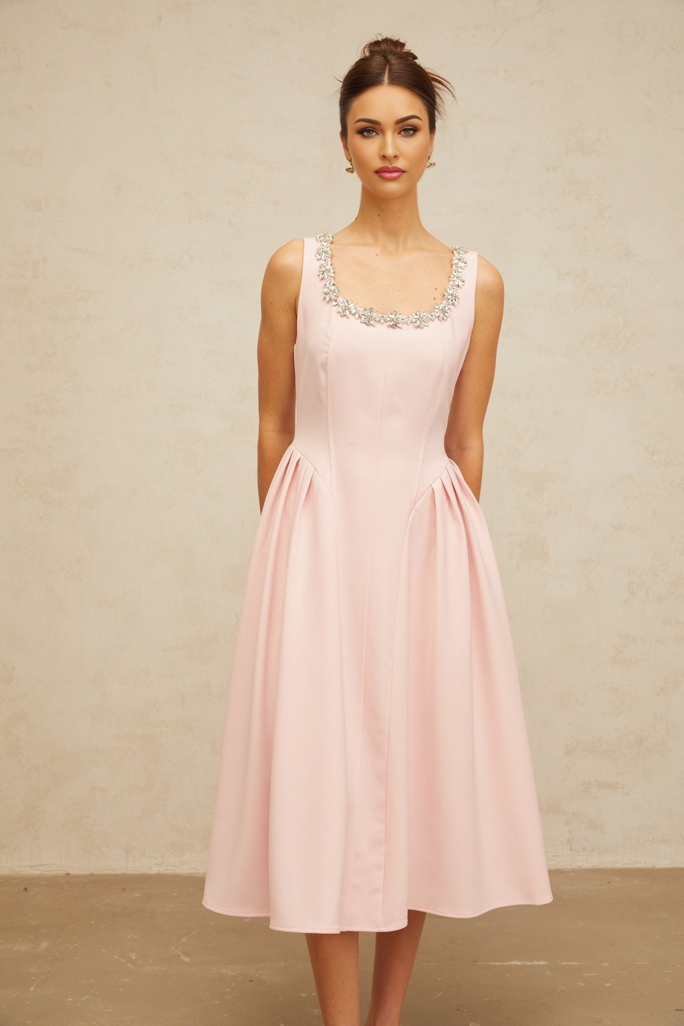 A pink midi dress with crystal embellishments and pleated details named Beatrice