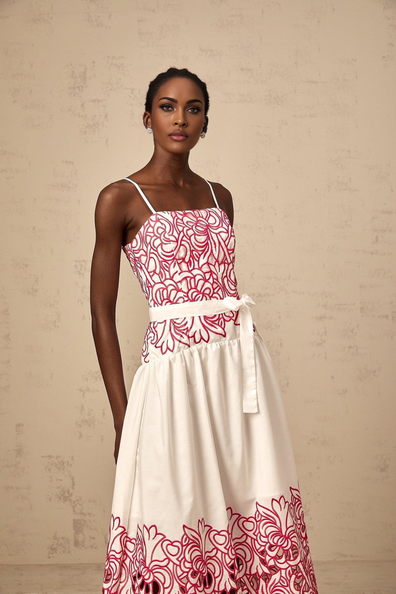 A pink midi dress with embroidery details and cut out sections named Beatrice