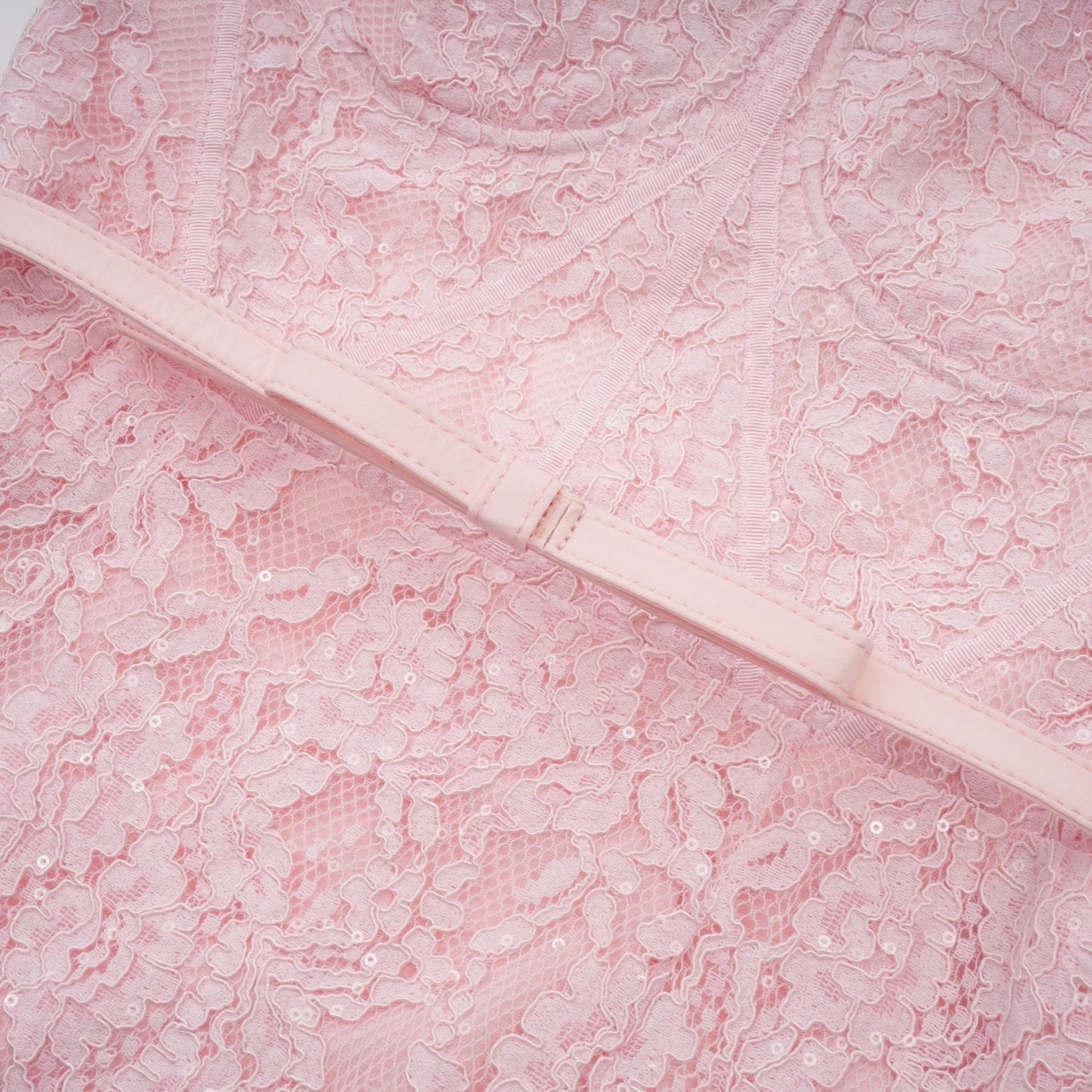 A pink midi dress with floral embroidery and lace details featuring embellishments and a delicate feminine design