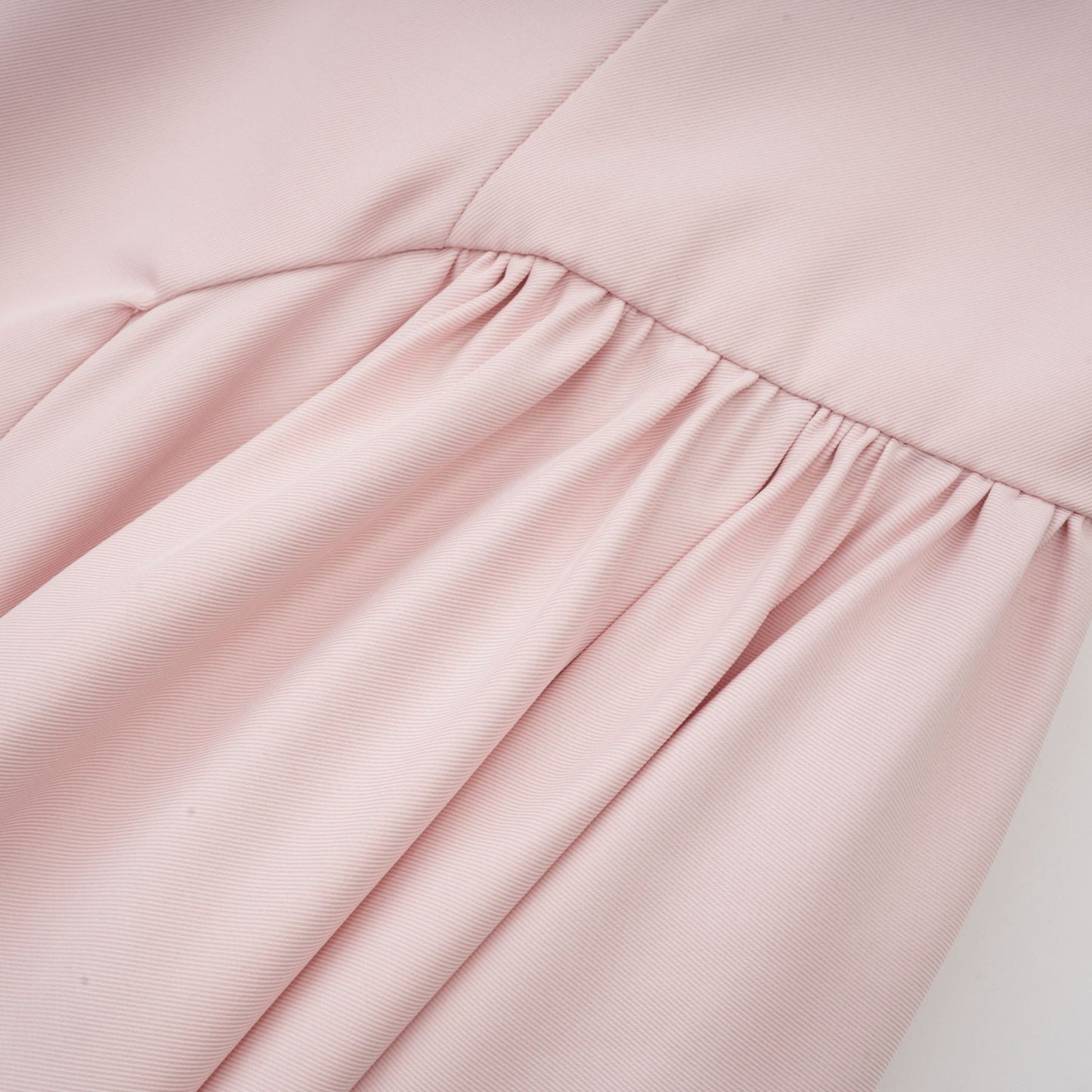 Pink sleeveless dress with delicate spaghetti straps bustier style top pleated design and flared skirt