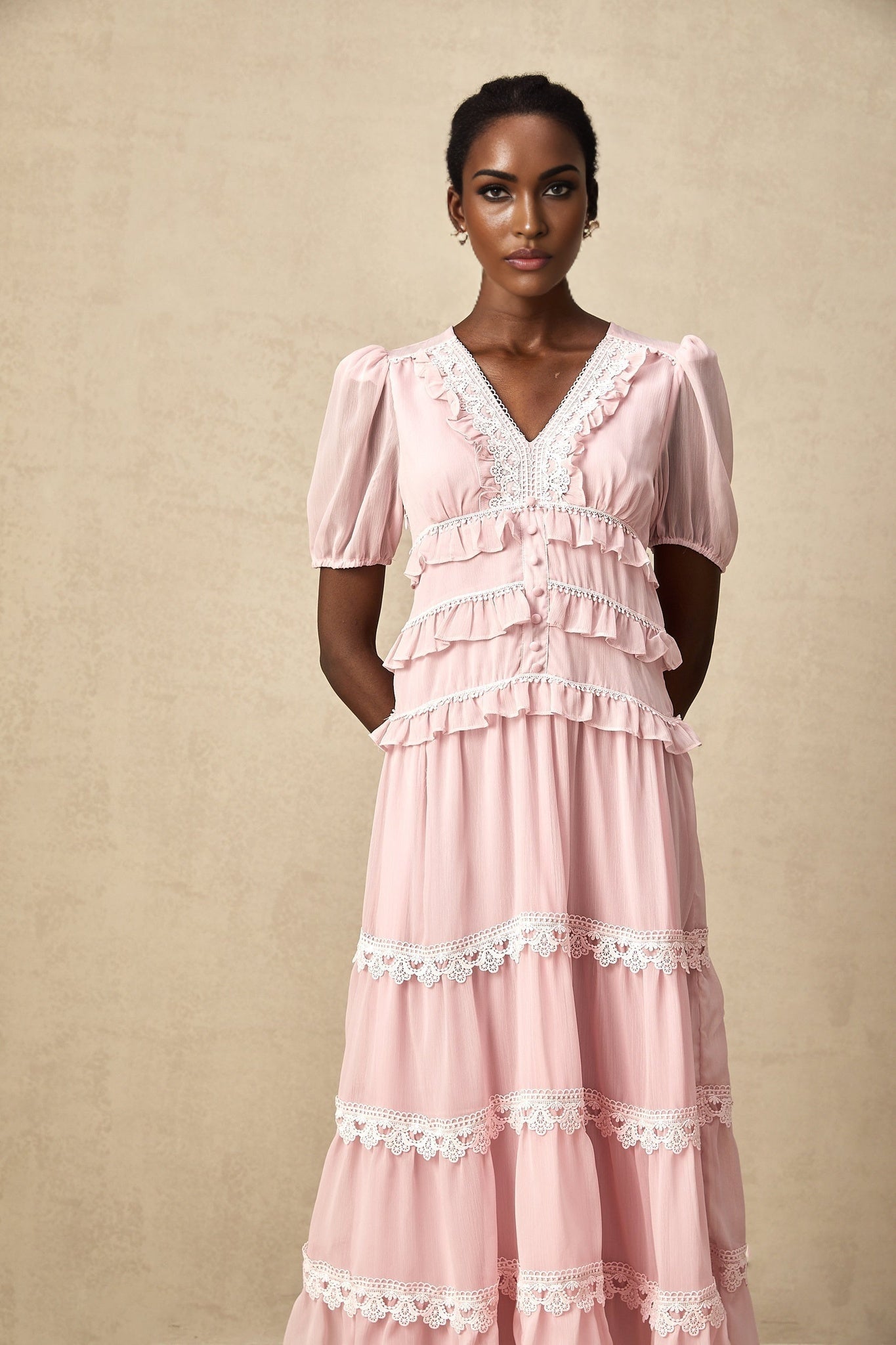 A pink midi dress with ruffled tiers and a feminine silhouette named Amelie