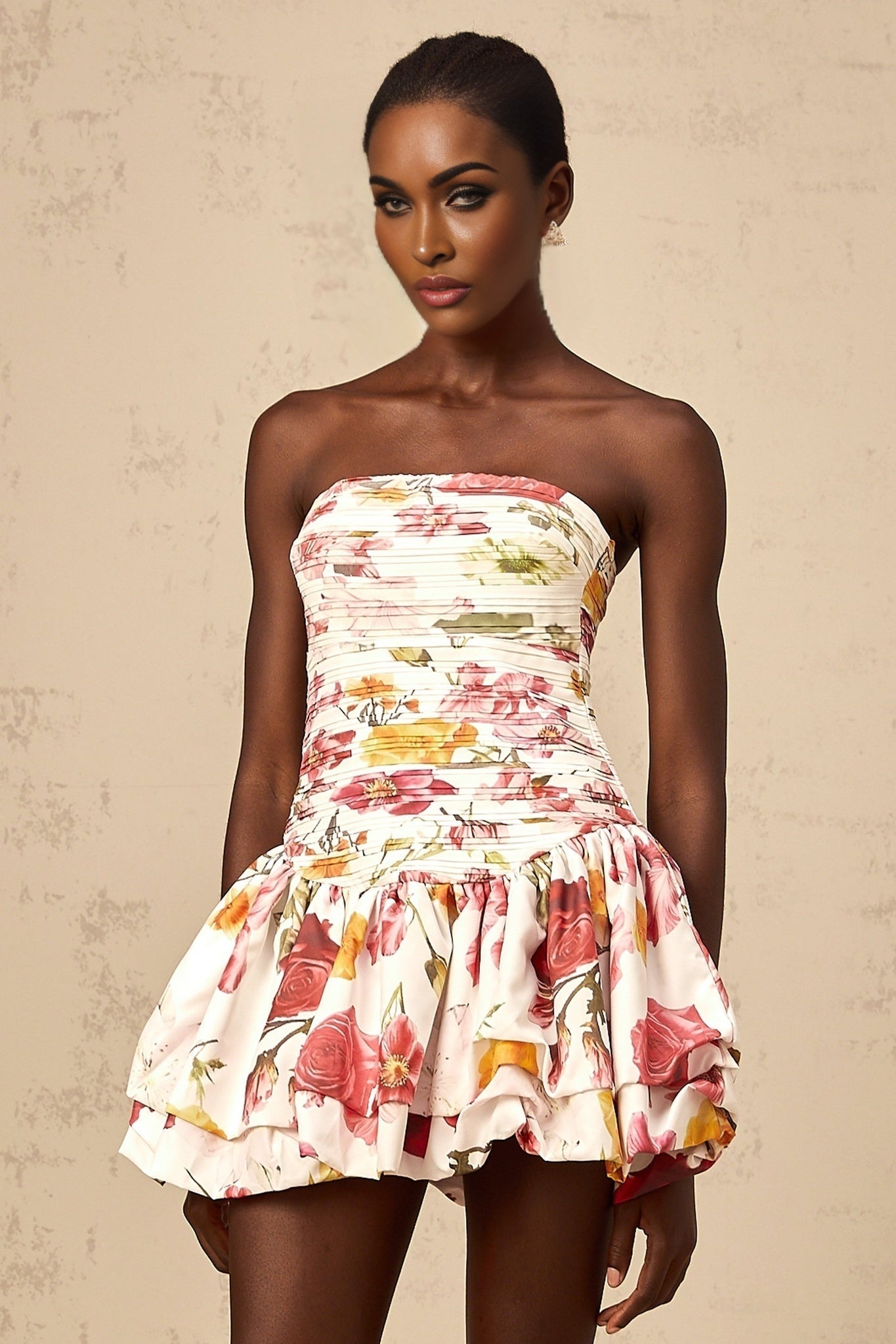 A pink mini dress with a floral print pattern and smocked detailing named Ines