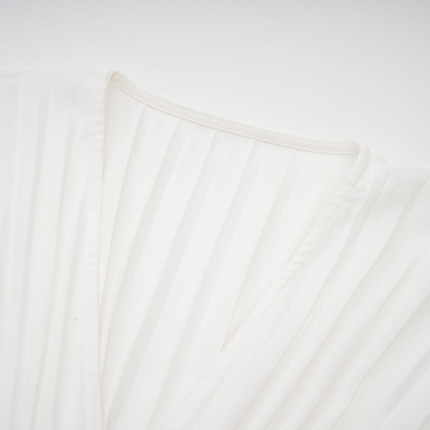 A plissé mini dress with a V neckline named Claudette