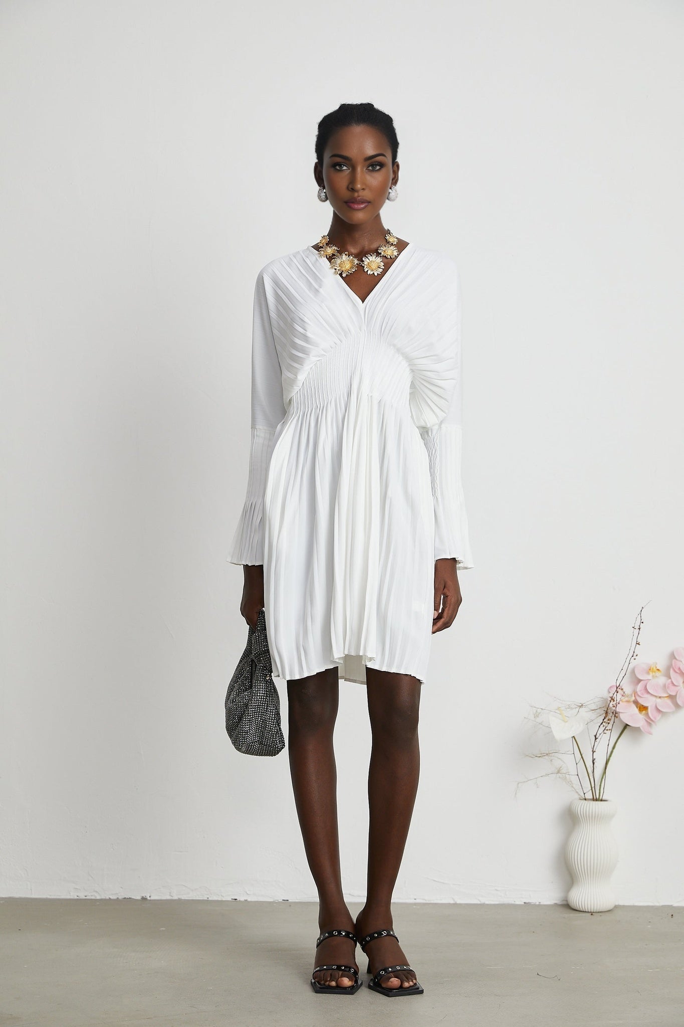 A plissé minidress named Claudette with a V neckline