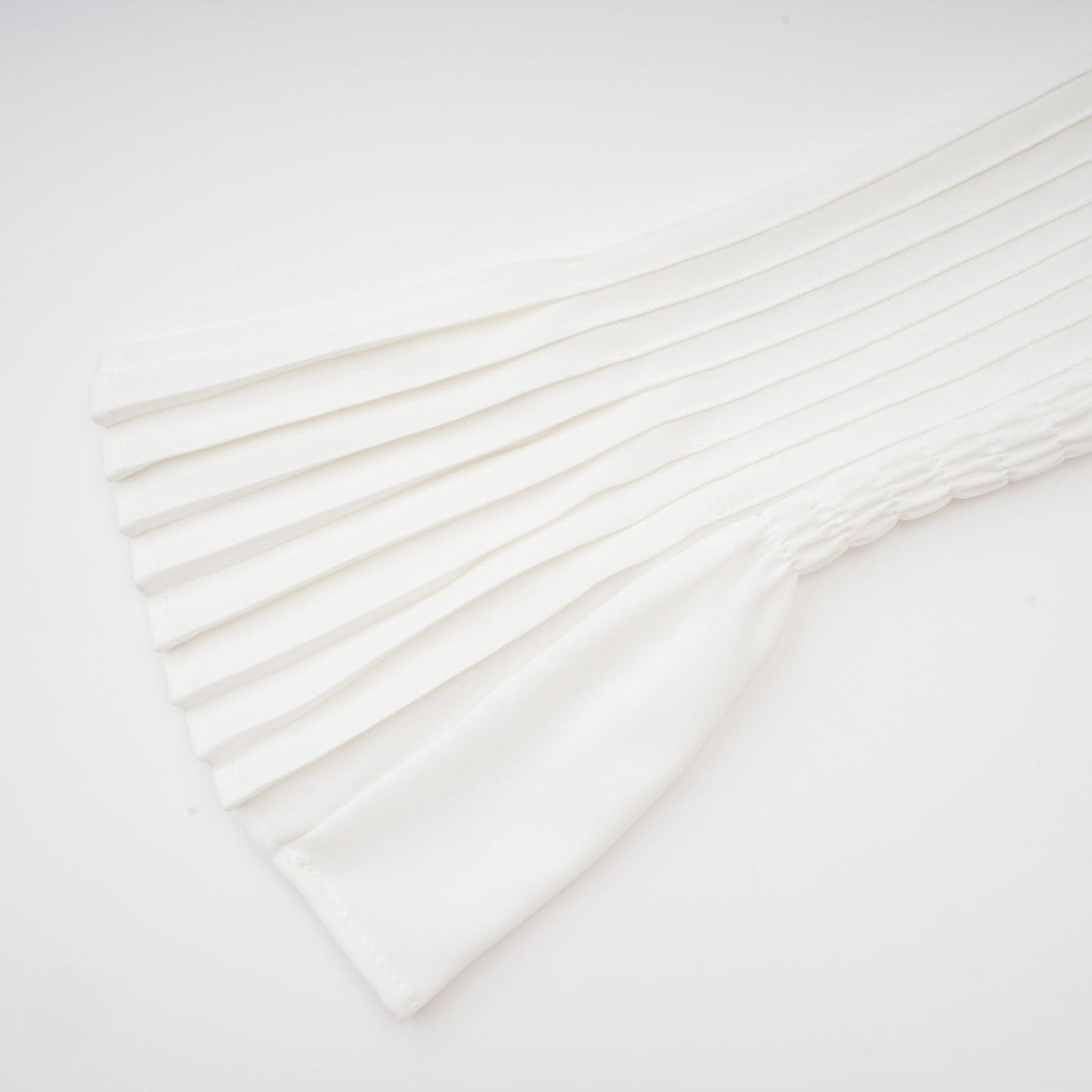 A plisse pleated mini dress with a V neckline in a light color likely featuring short sleeves and a fitted silhouette named Claudette