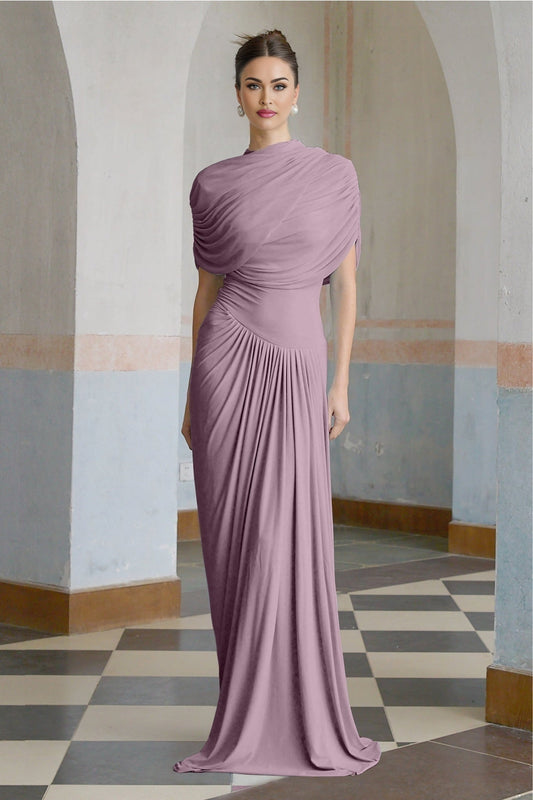 A purple asymmetric maxi dress with pleated details and a long flowing skirt worn by a model standing against a plain background