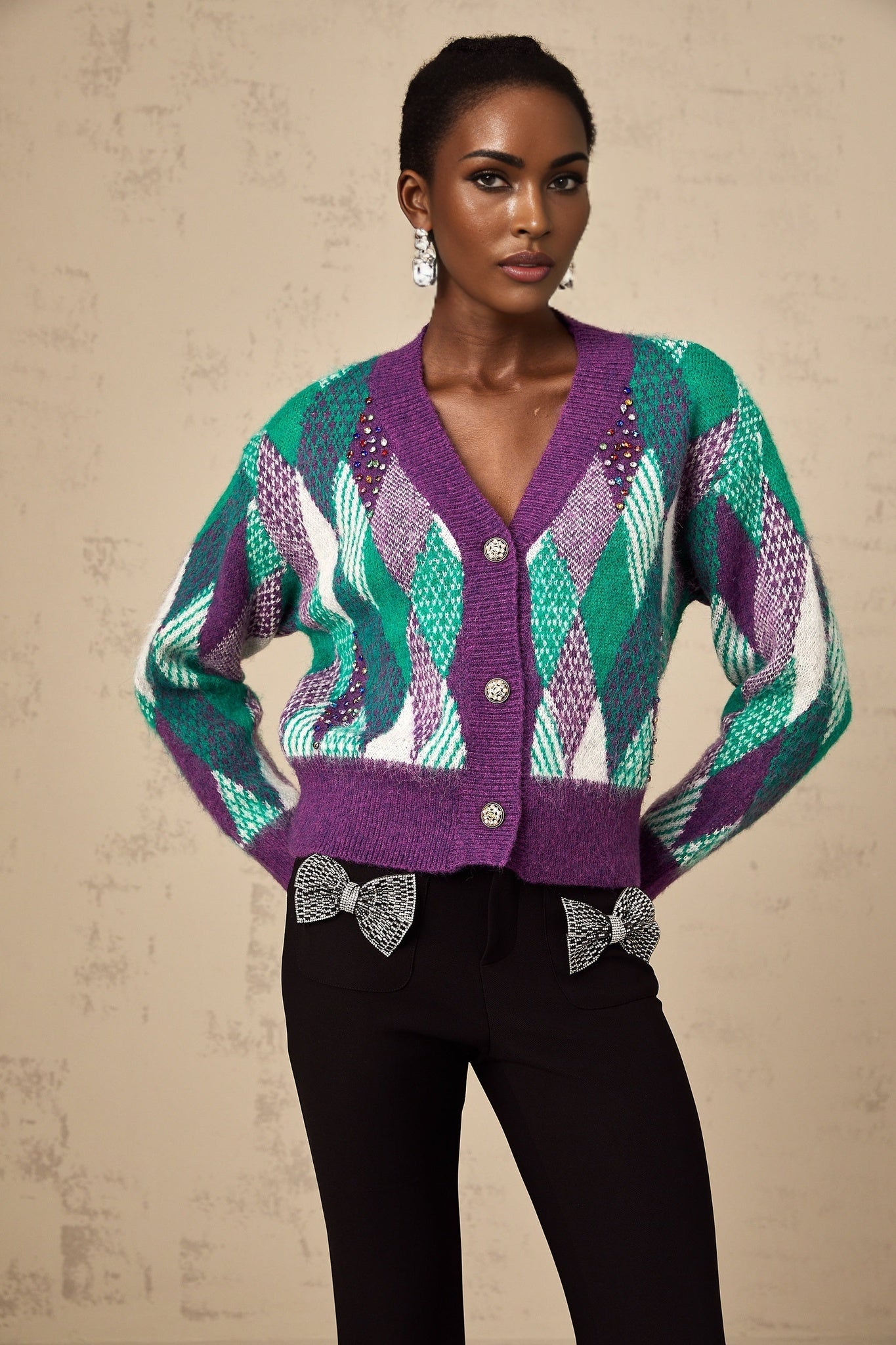 A purple knit top with an argyle pattern featuring a classic design and soft texture