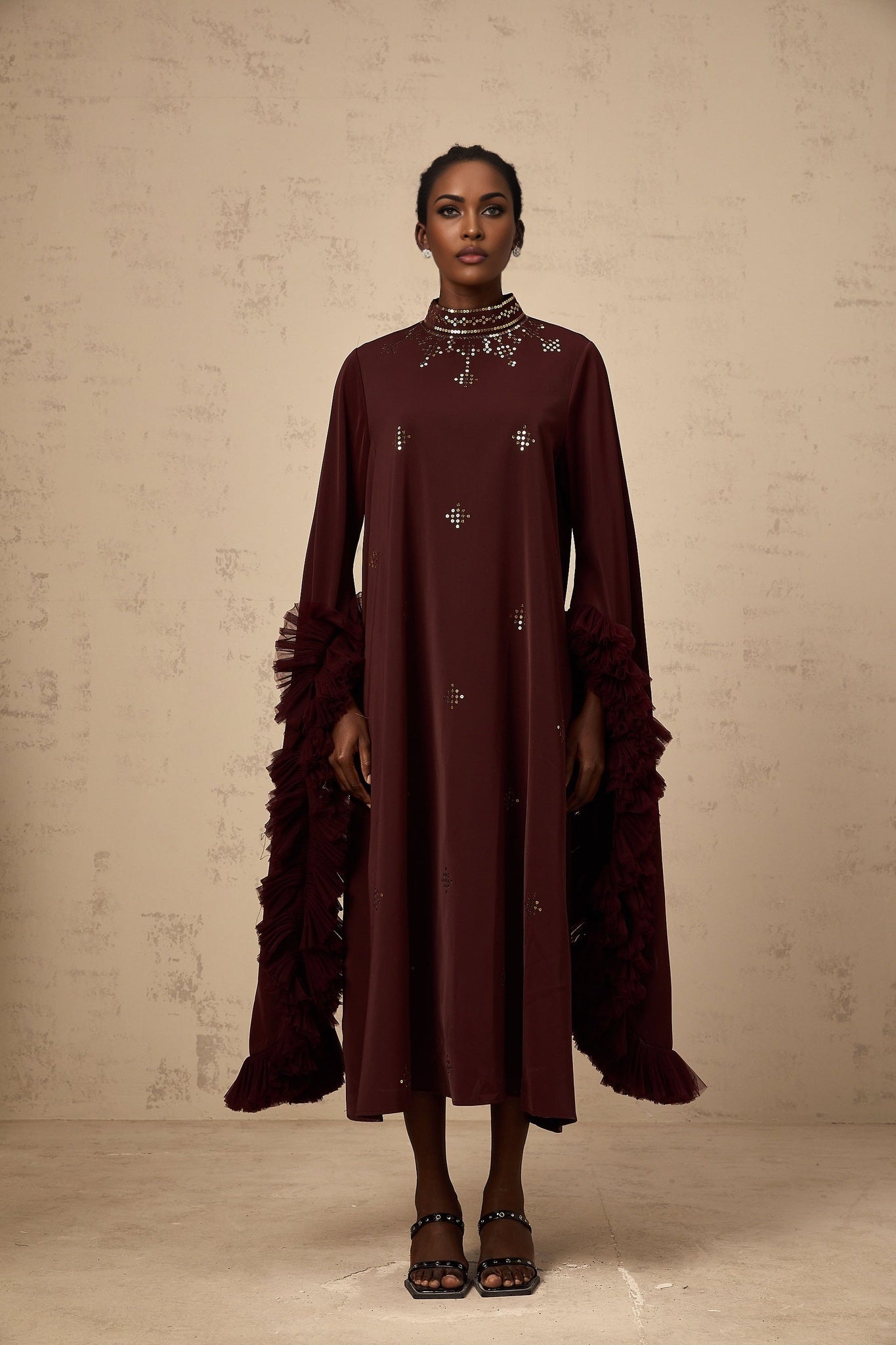 A purple midi dress with sequin embellishments and flared sleeves featuring a design by Anais